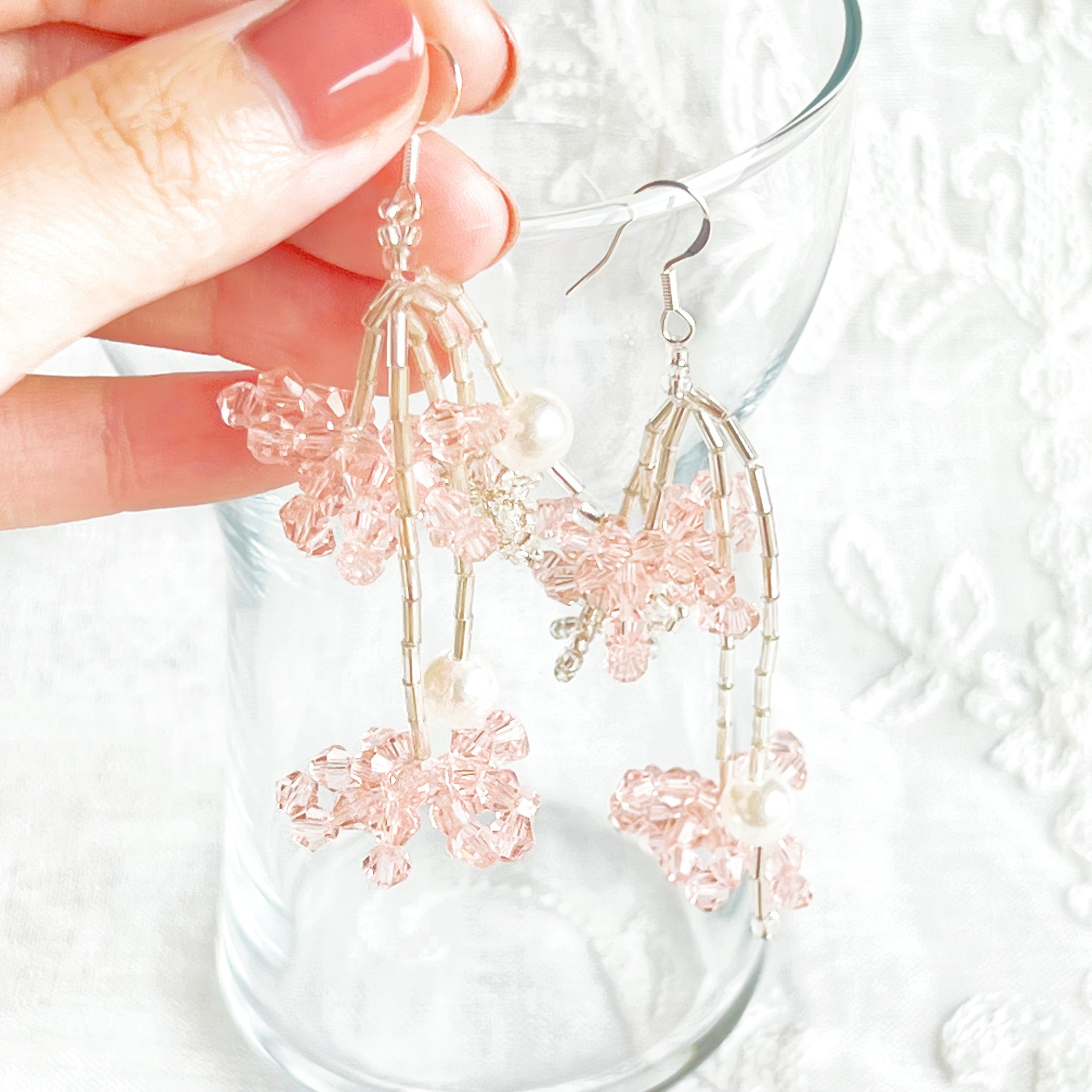 A pair of pink beaded flower statement earrings featuring vibrant acrylic beads and sterling silver ear wires, beautifully arranged in a gift box.