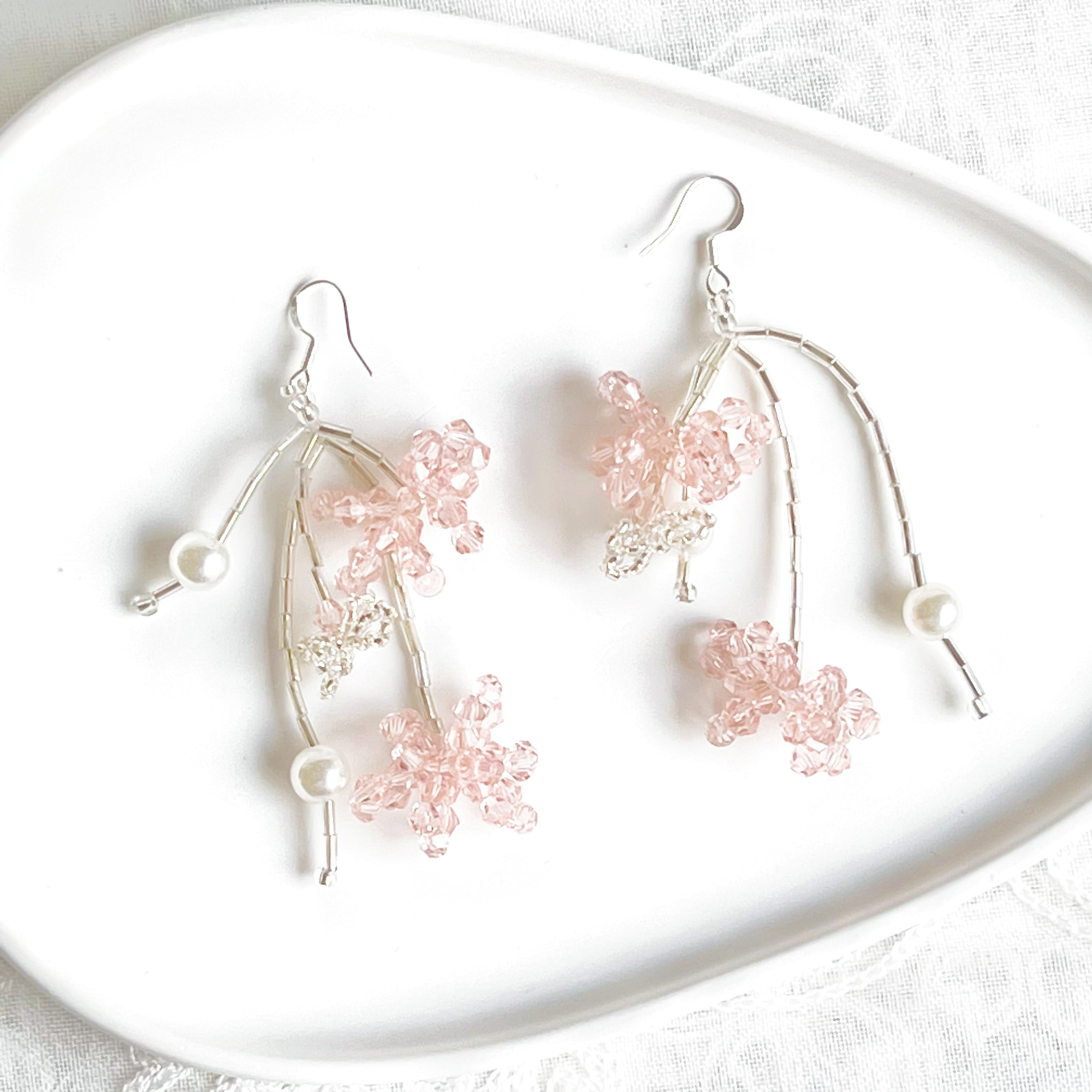 A pair of pink beaded flower statement earrings featuring vibrant acrylic beads and sterling silver ear wires, beautifully arranged in a gift box.