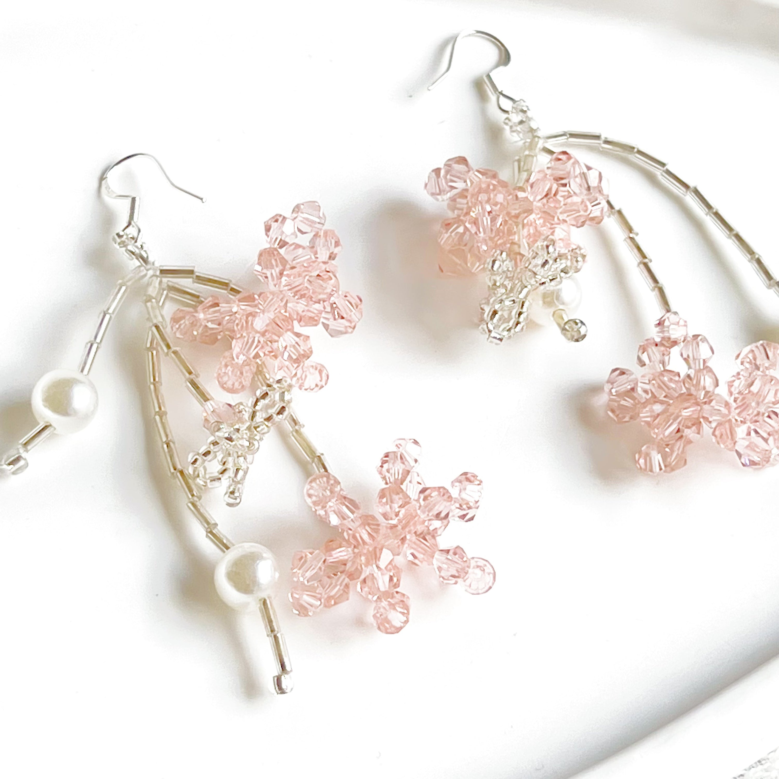 A pair of pink beaded flower statement earrings featuring vibrant acrylic beads and sterling silver ear wires, beautifully arranged in a gift box.