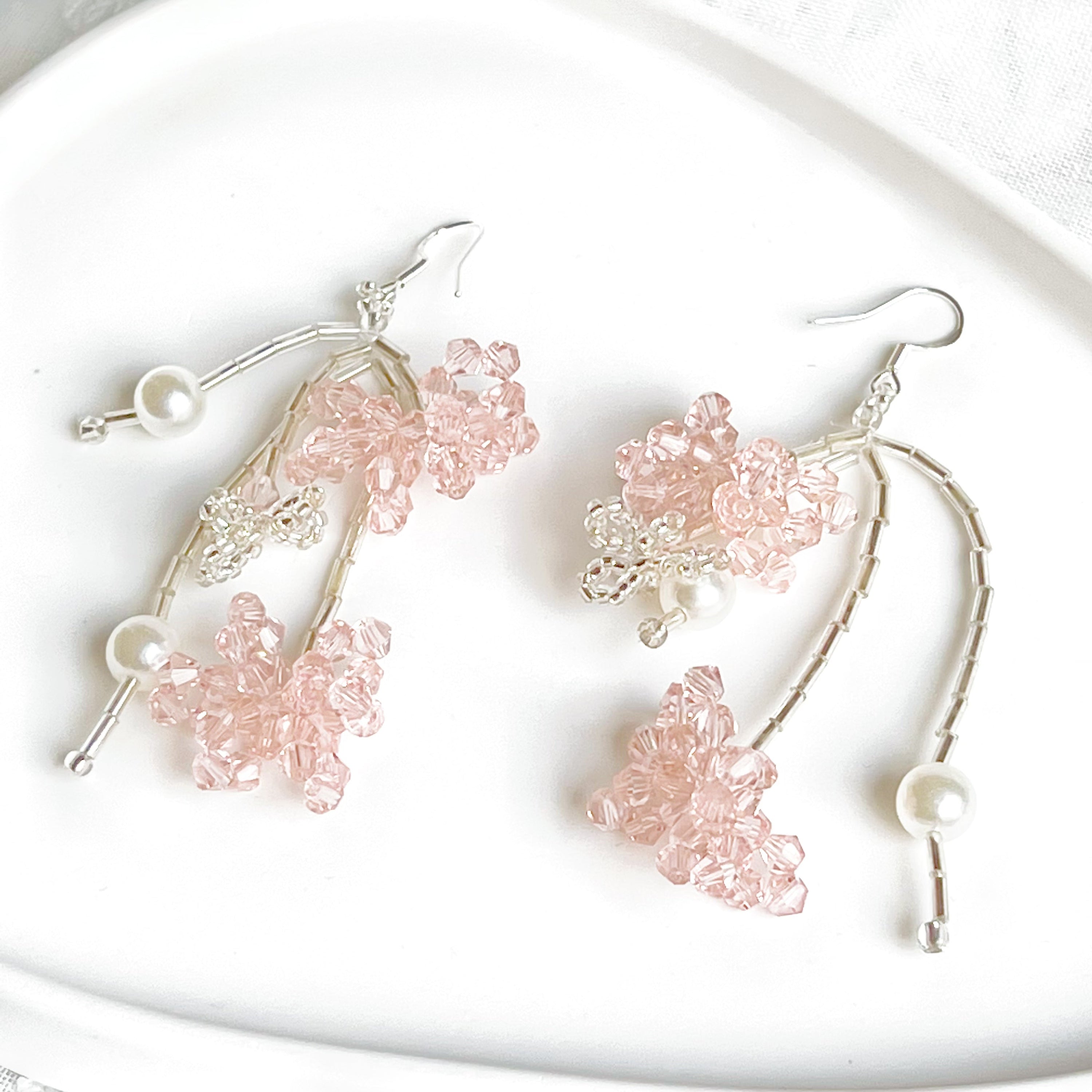 A pair of pink beaded flower statement earrings featuring vibrant acrylic beads and sterling silver ear wires, beautifully arranged in a gift box.