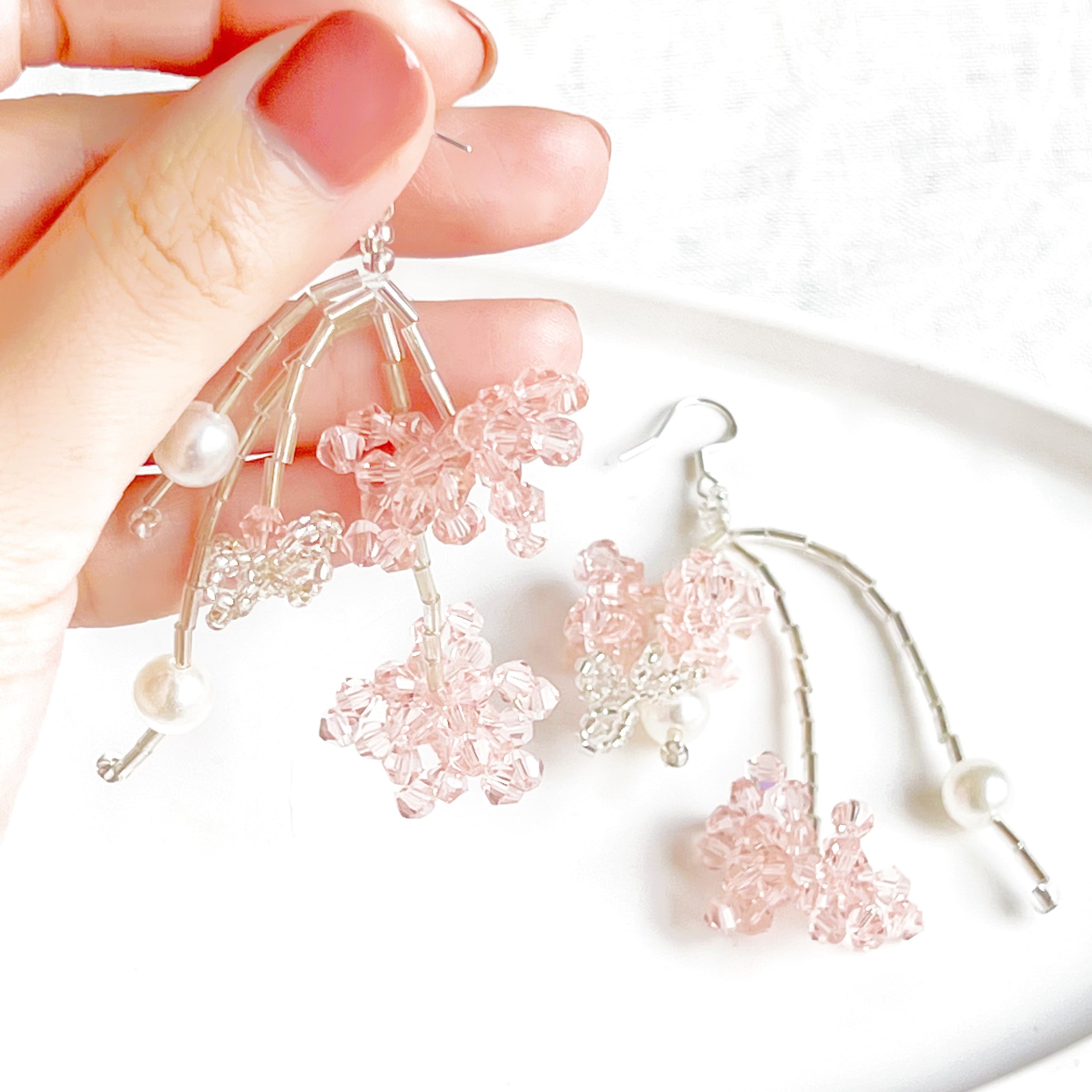 A pair of pink beaded flower statement earrings featuring vibrant acrylic beads and sterling silver ear wires, beautifully arranged in a gift box.