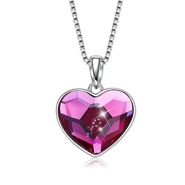 A beautiful heart-shaped necklace featuring pink elements stone, crafted in 14K white gold plating with a link chain.