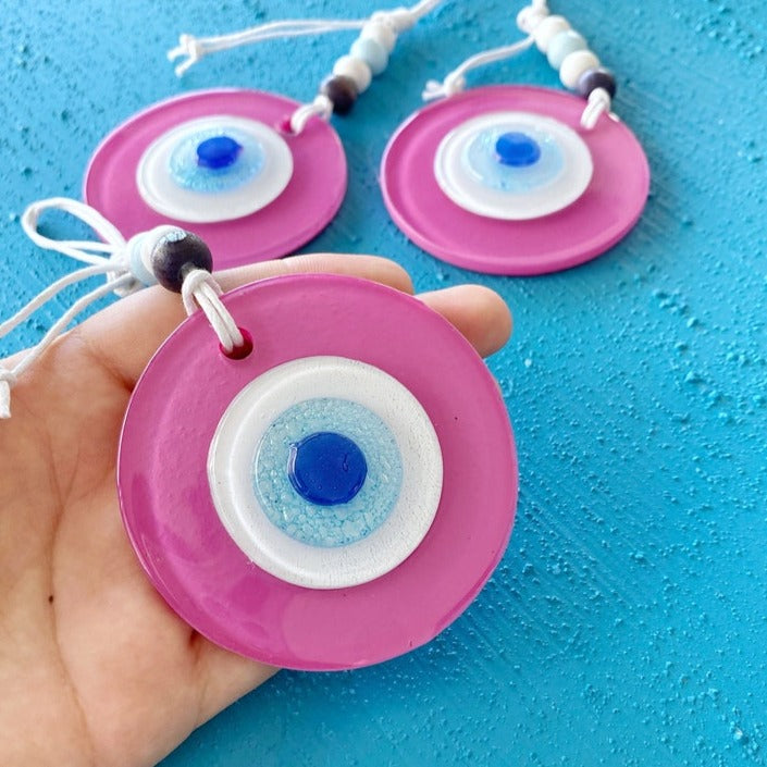 A beautiful handmade Pink Evil Eye Glass Bead wall hanging, featuring a vibrant pink color and intricate design, symbolizing protection and purity.