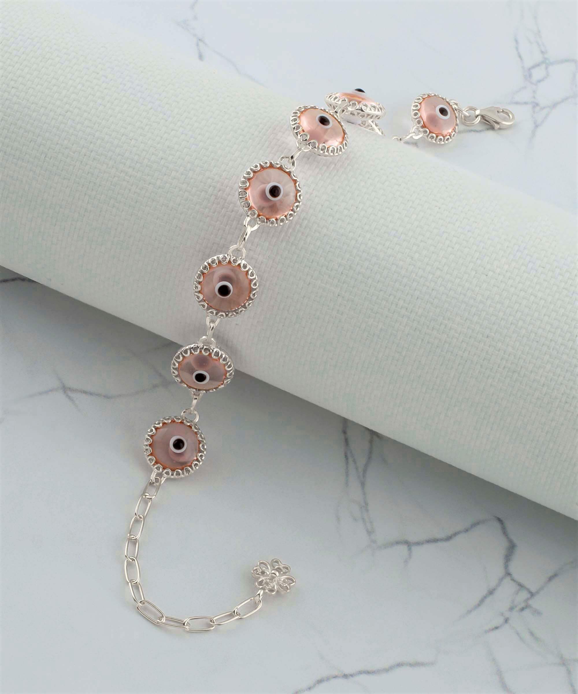 A stylish Pink Evil Eye Sterling Silver Adjustable Link Bracelet featuring a strong rolo chain and protective evil eye beads.