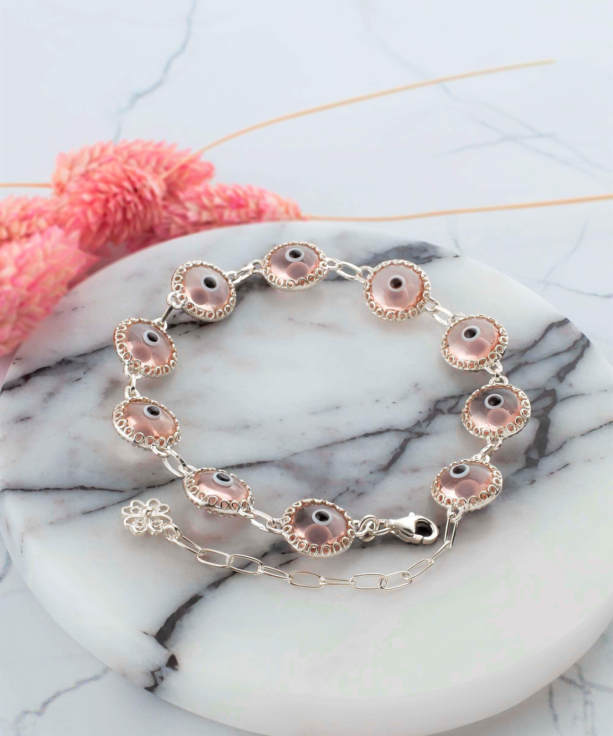 A stylish Pink Evil Eye Sterling Silver Adjustable Link Bracelet featuring a strong rolo chain and protective evil eye beads.