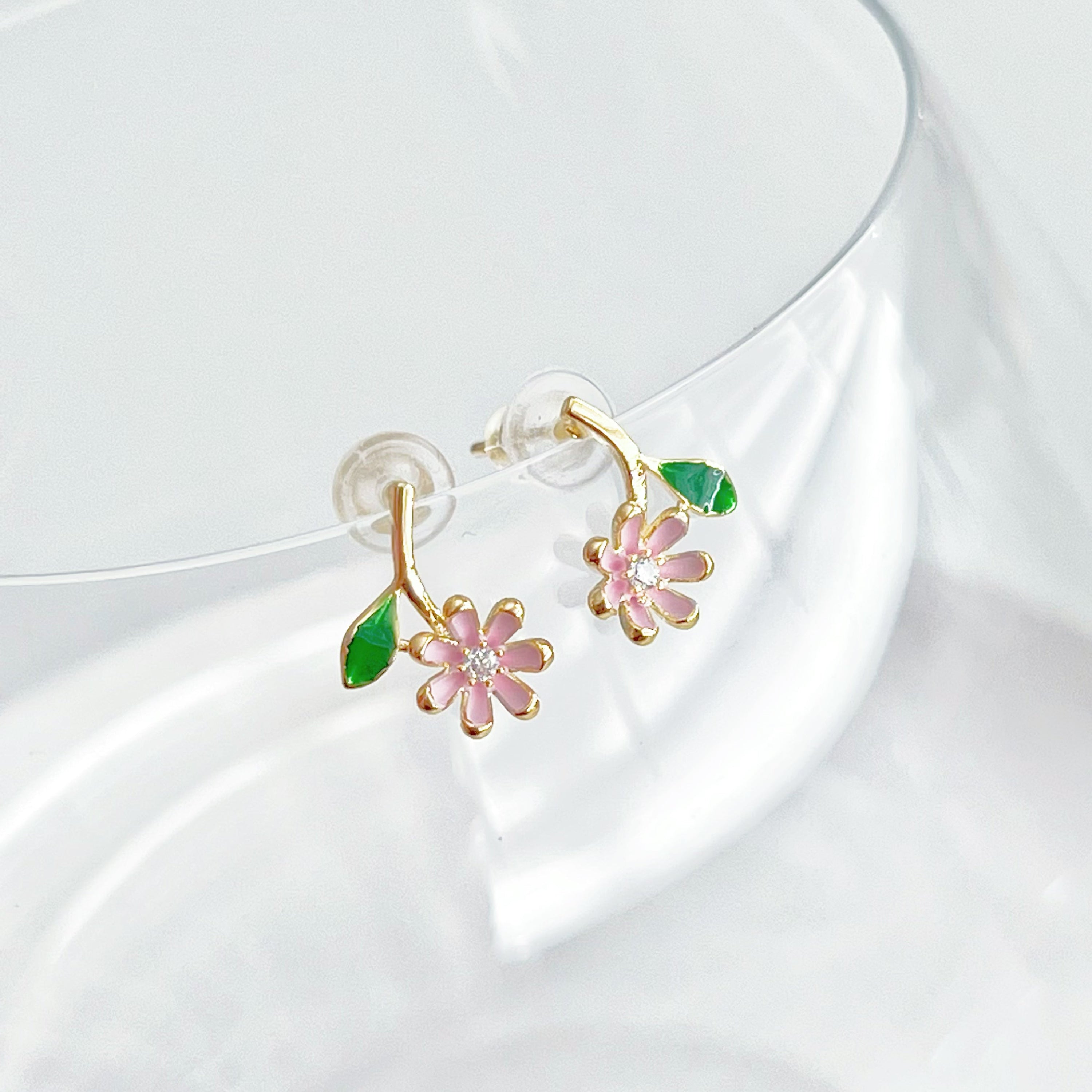 A pair of Pink Little Wildflower Earrings featuring gold plated bronze and sterling silver, elegantly designed with glass crystals.