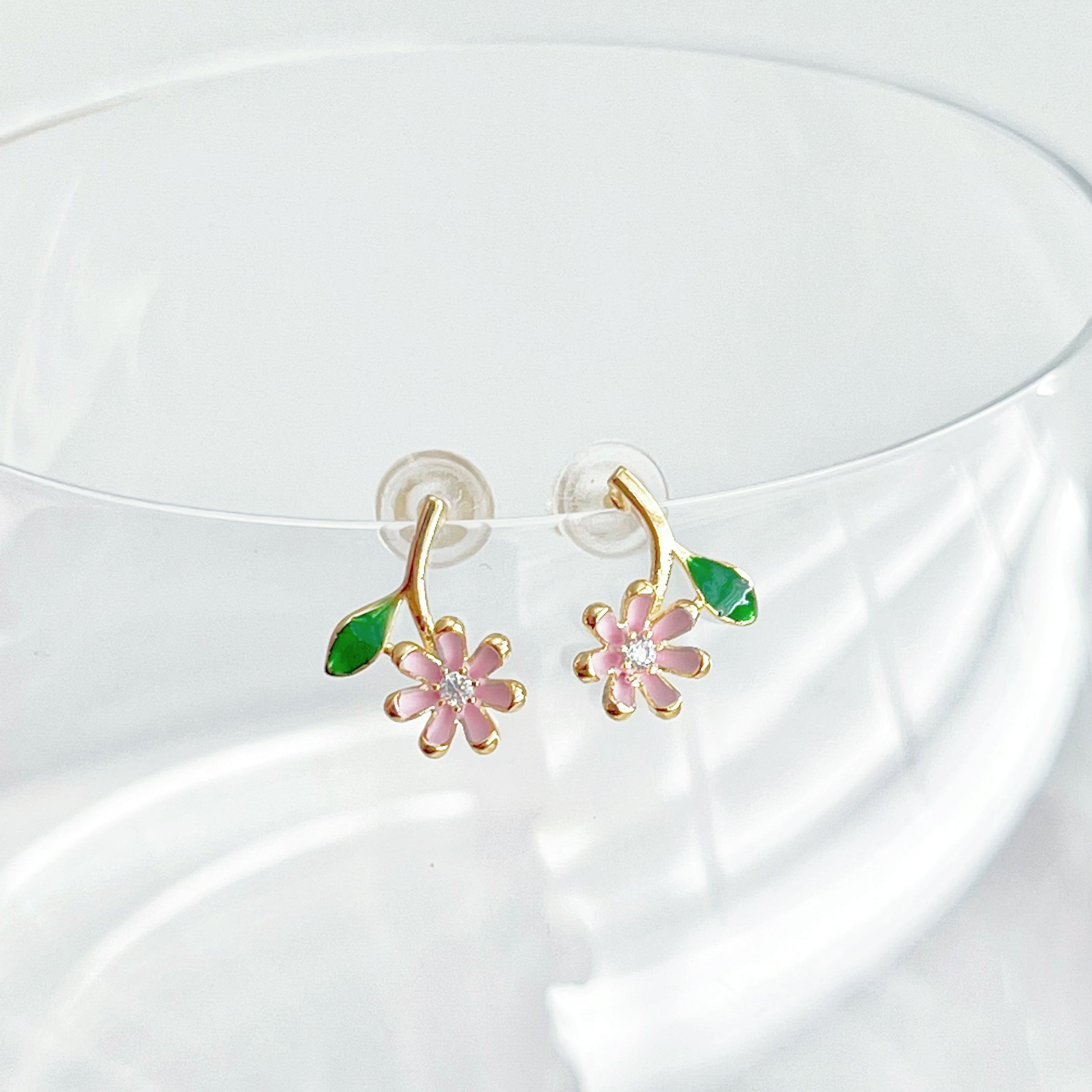 A pair of Pink Little Wildflower Earrings featuring gold plated bronze and sterling silver, elegantly designed with glass crystals.