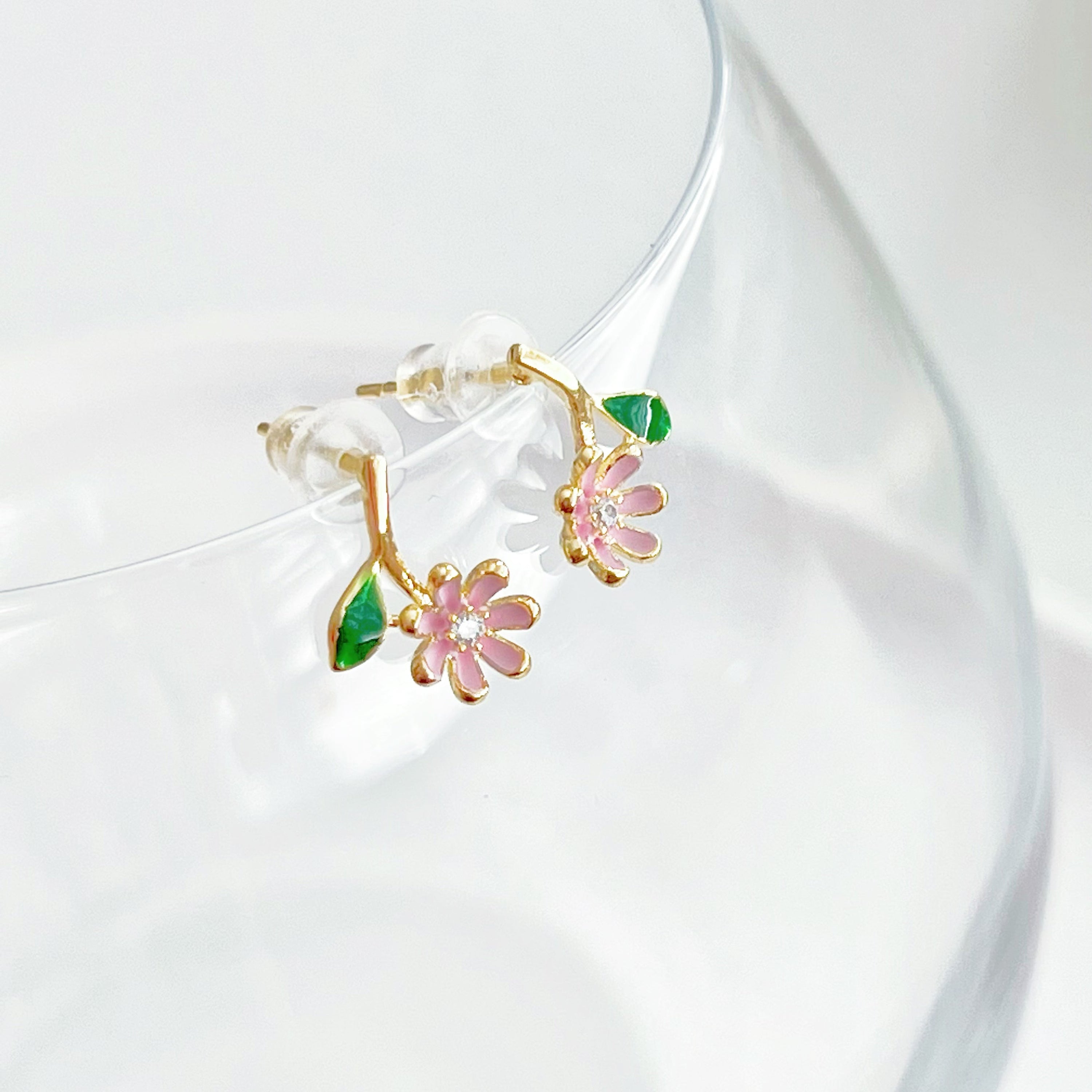 A pair of Pink Little Wildflower Earrings featuring gold plated bronze and sterling silver, elegantly designed with glass crystals.