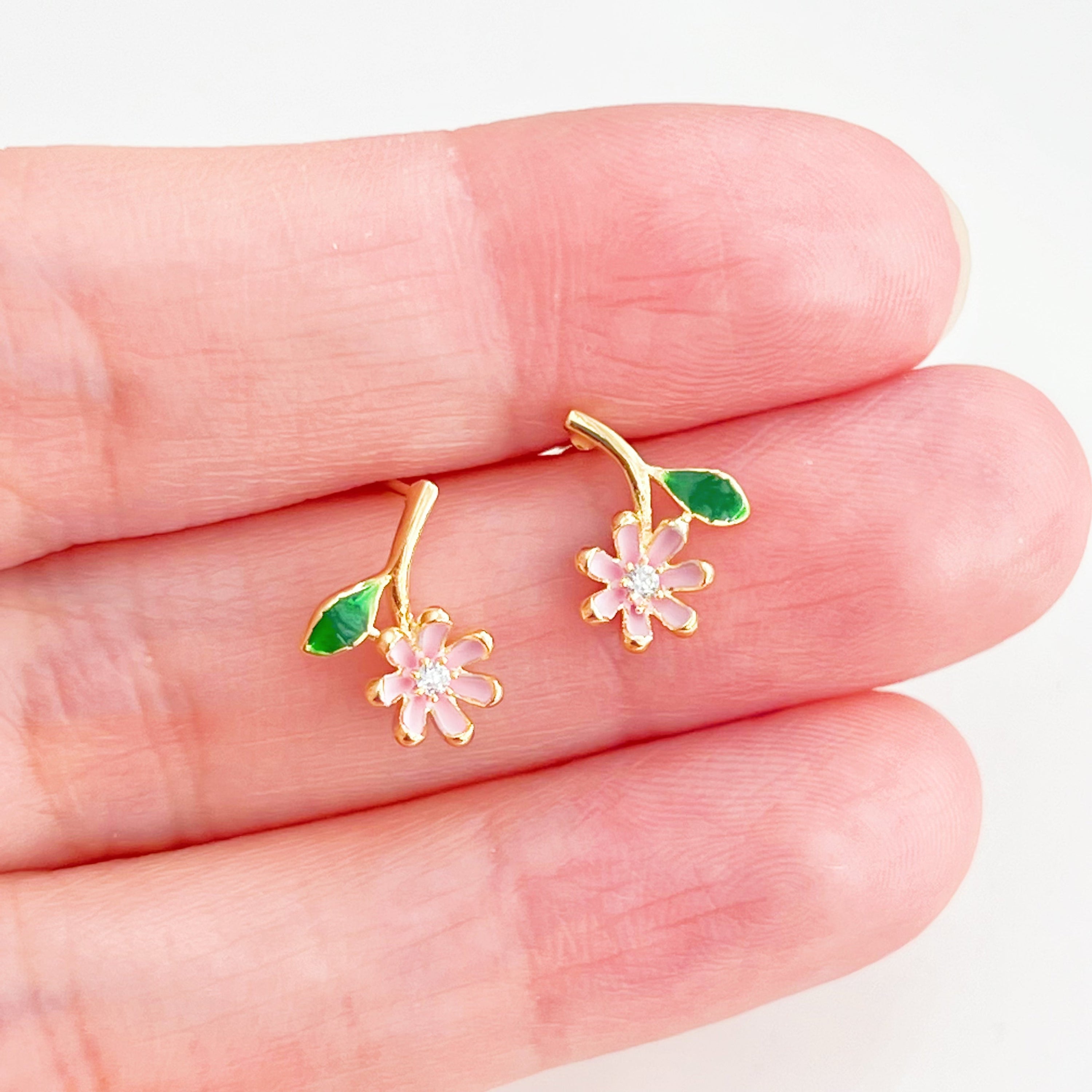 A pair of Pink Little Wildflower Earrings featuring gold plated bronze and sterling silver, elegantly designed with glass crystals.