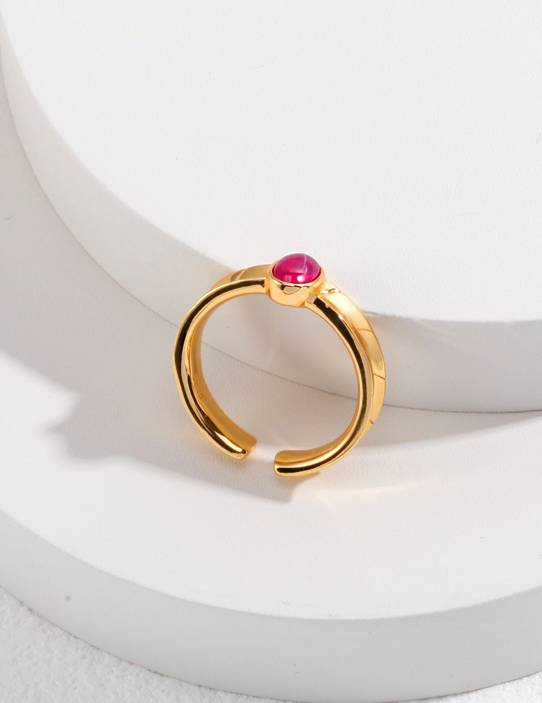 A stunning pink oval shaped zircon ring set in sterling silver with gold vermeil accents, showcasing its elegant design.