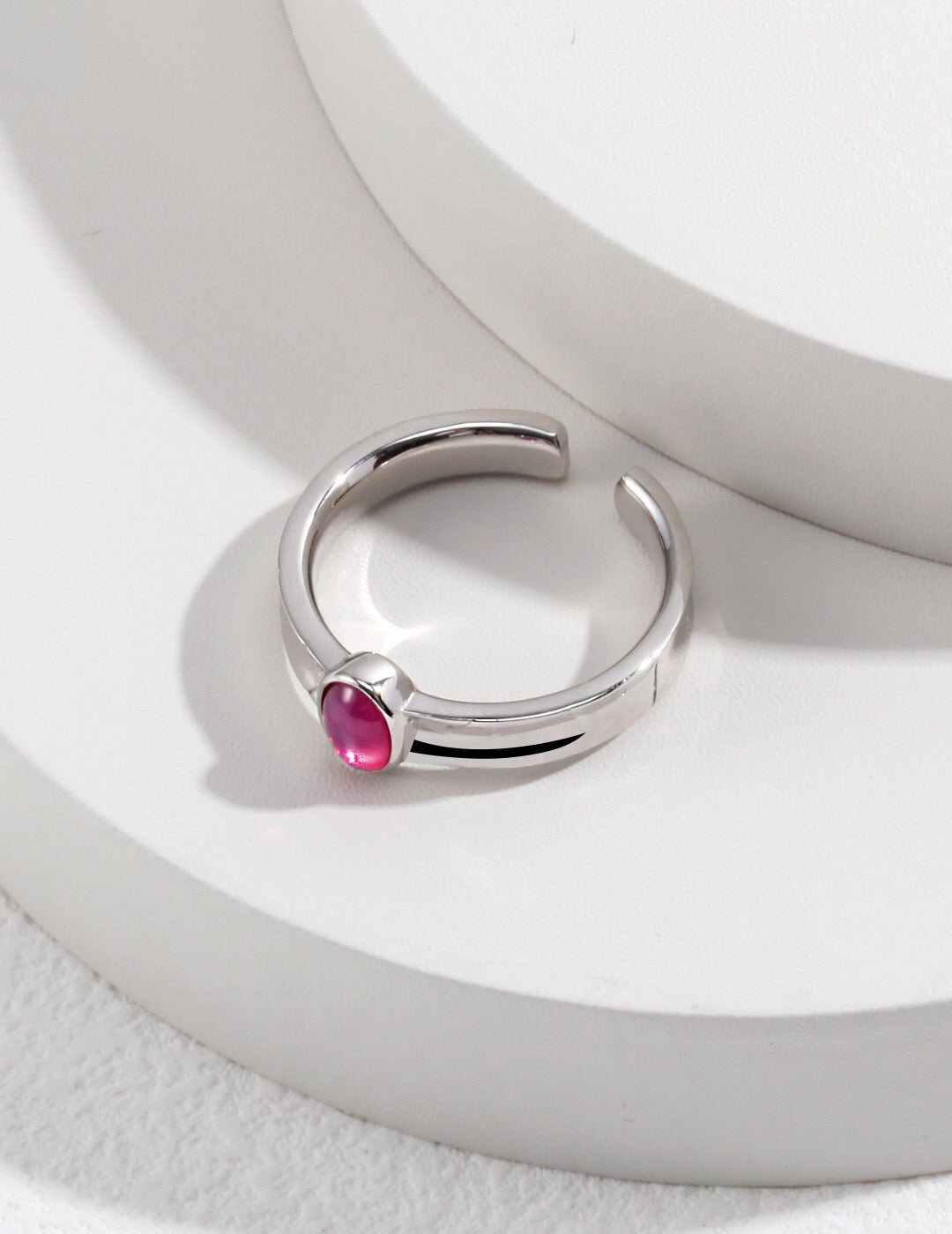 A stunning pink oval shaped zircon ring set in sterling silver with gold vermeil accents, showcasing its elegant design.