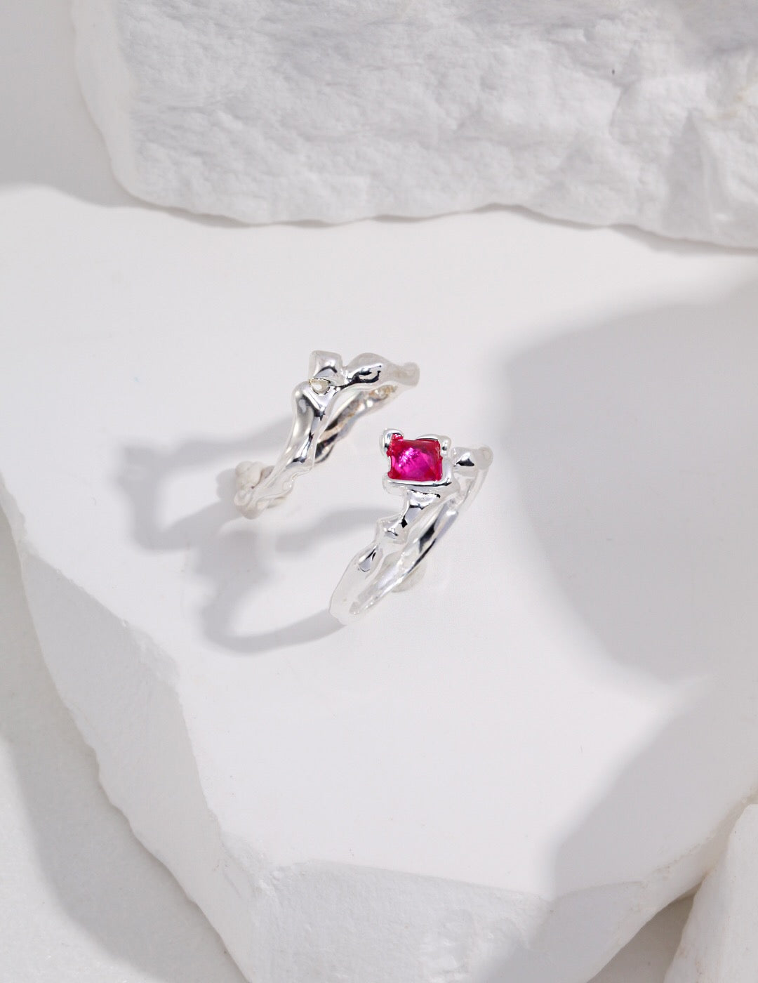 A stunning pink rhombus shaped zircon ring made from sterling silver and gold vermeil, showcasing its elegant design and sparkling stone.