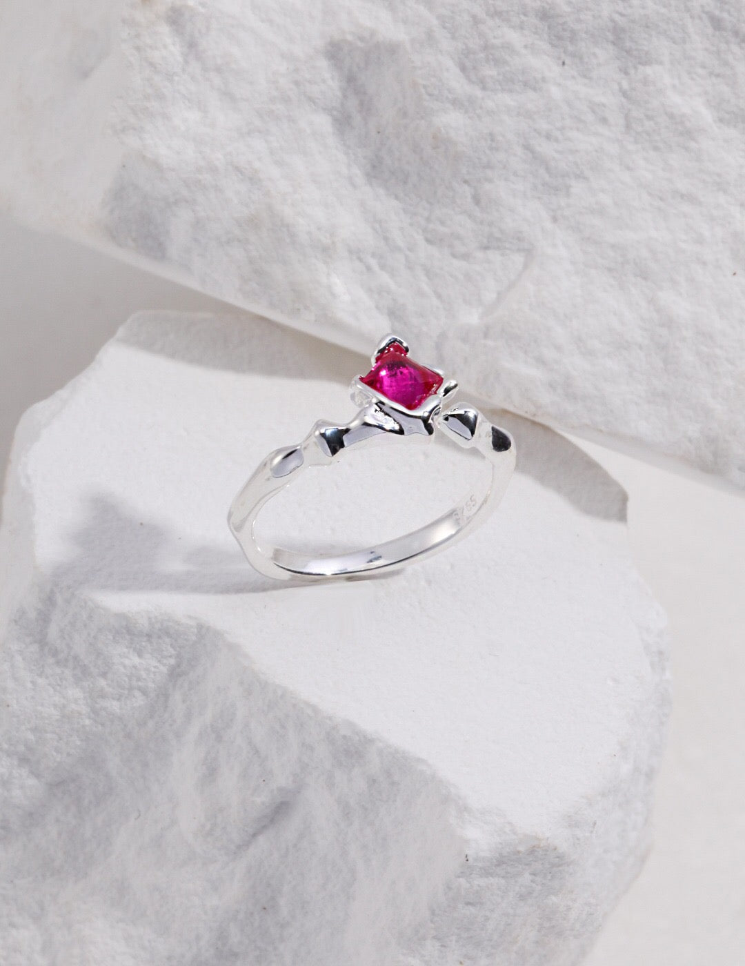 A stunning pink rhombus shaped zircon ring made from sterling silver and gold vermeil, showcasing its elegant design and sparkling stone.