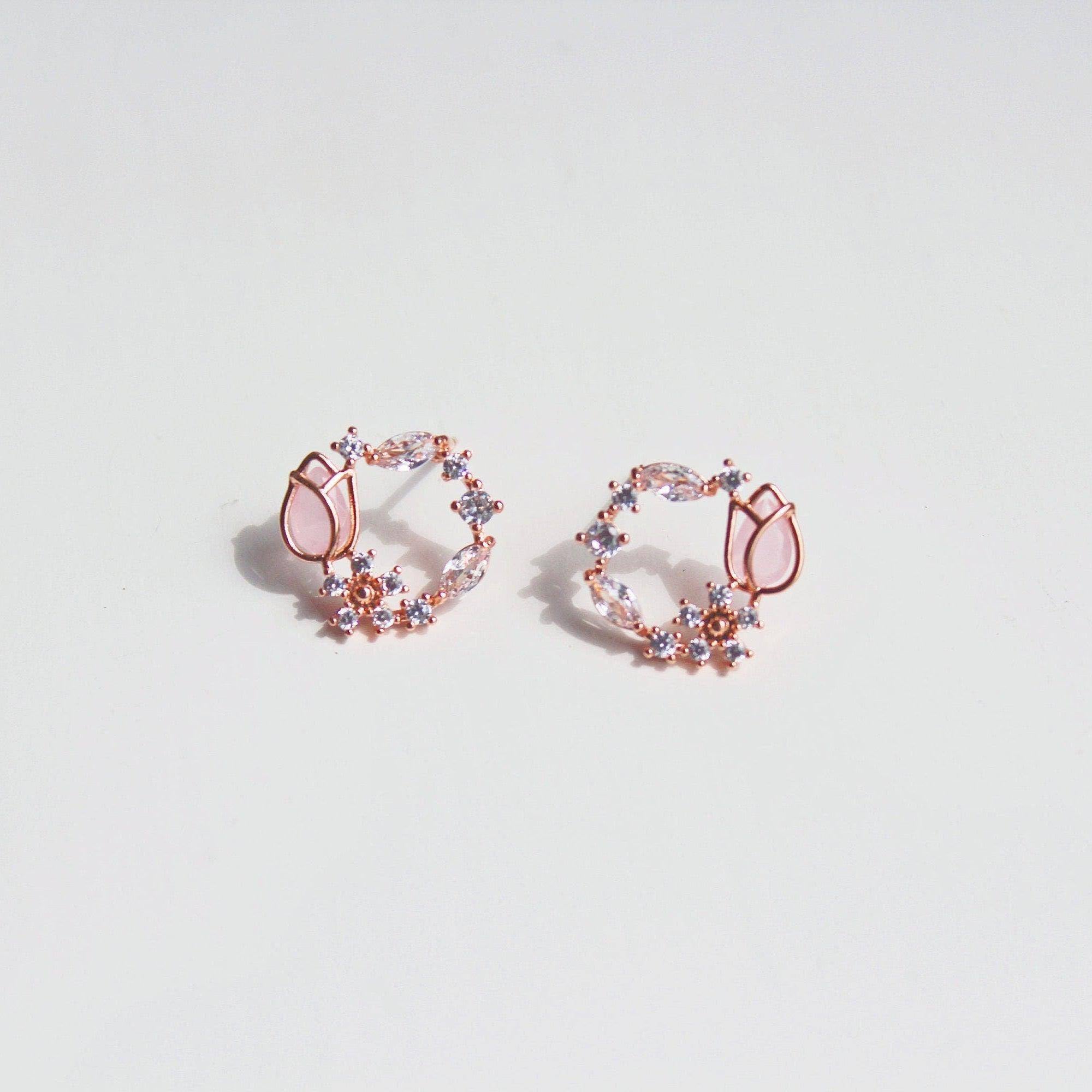 Elegant pink tulip earrings featuring flower-shaped crystal design in rose gold plating.