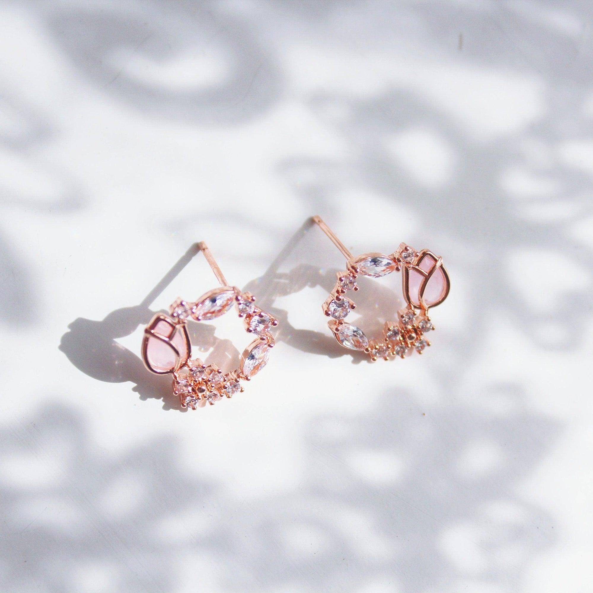 Elegant pink tulip earrings featuring flower-shaped crystal design in rose gold plating.