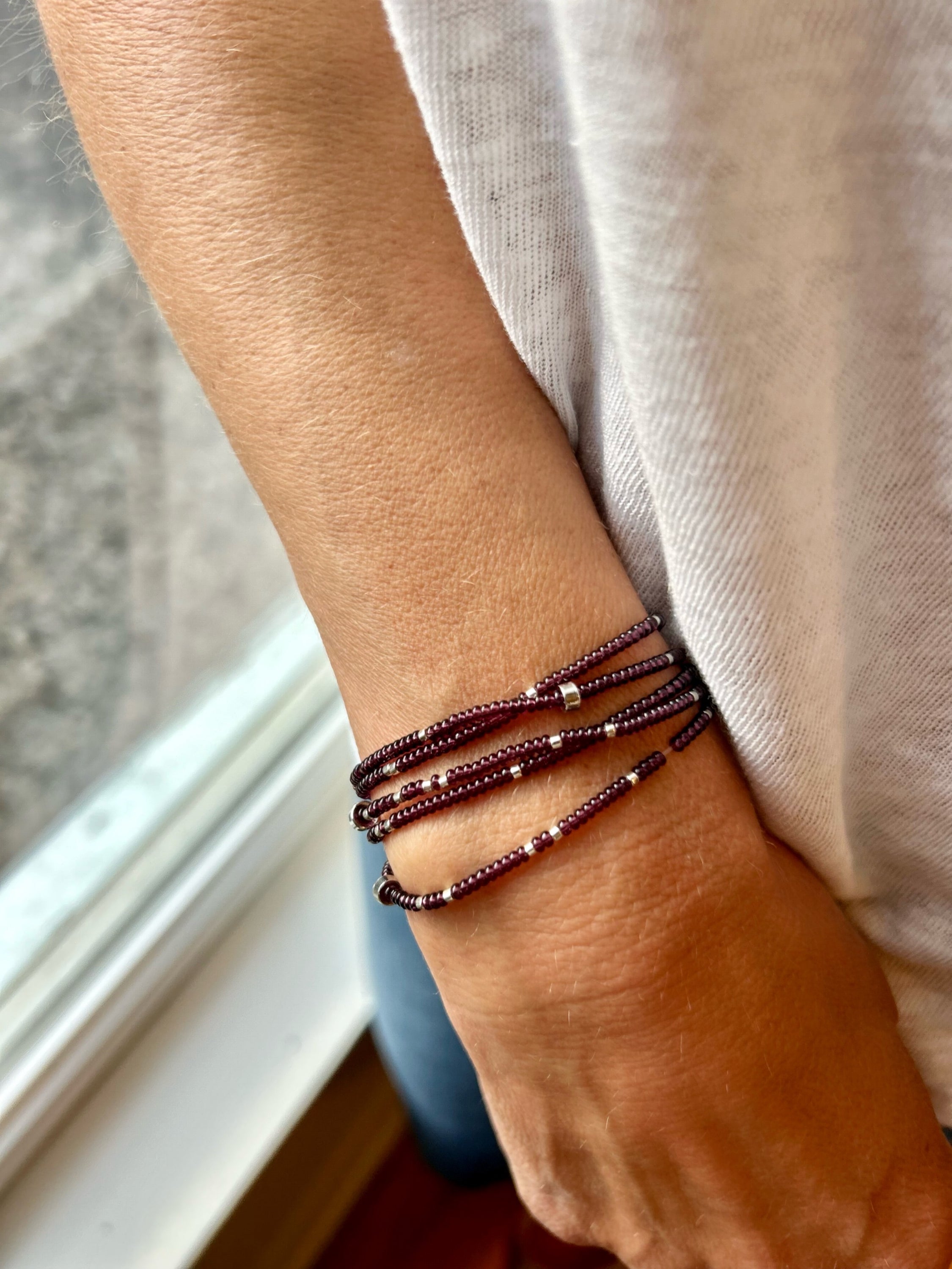 Plum purple beaded 5-wrap bracelet with silver sprinkles, showcasing Czech glass seed beads and strong elastic cording.