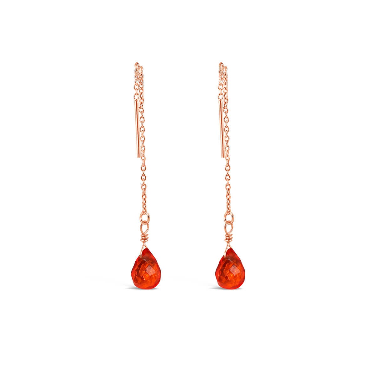 Dangling earrings with orange gemstones.