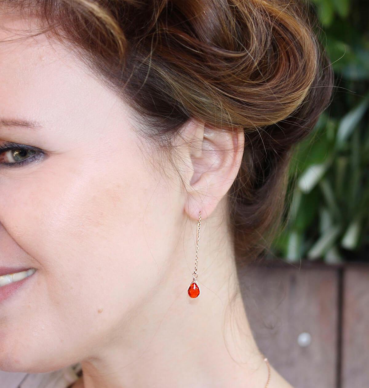 Close-up of a red earring.