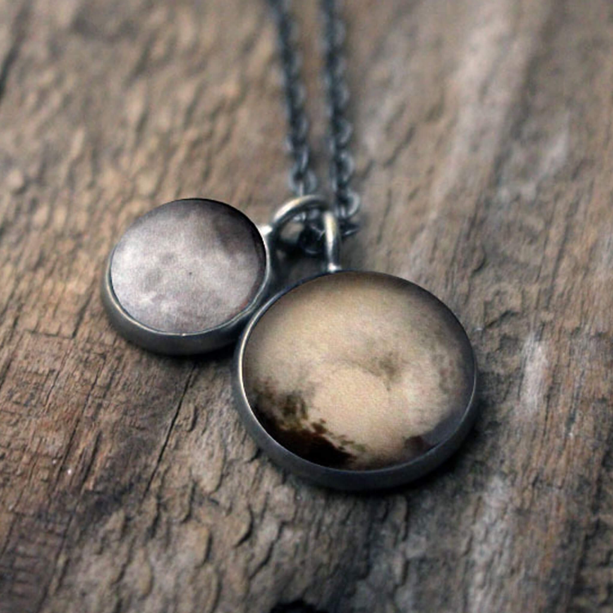 Layered necklace featuring Pluto and its moon Charon, inspired by New Horizons images, handcrafted with plated brass and glass.