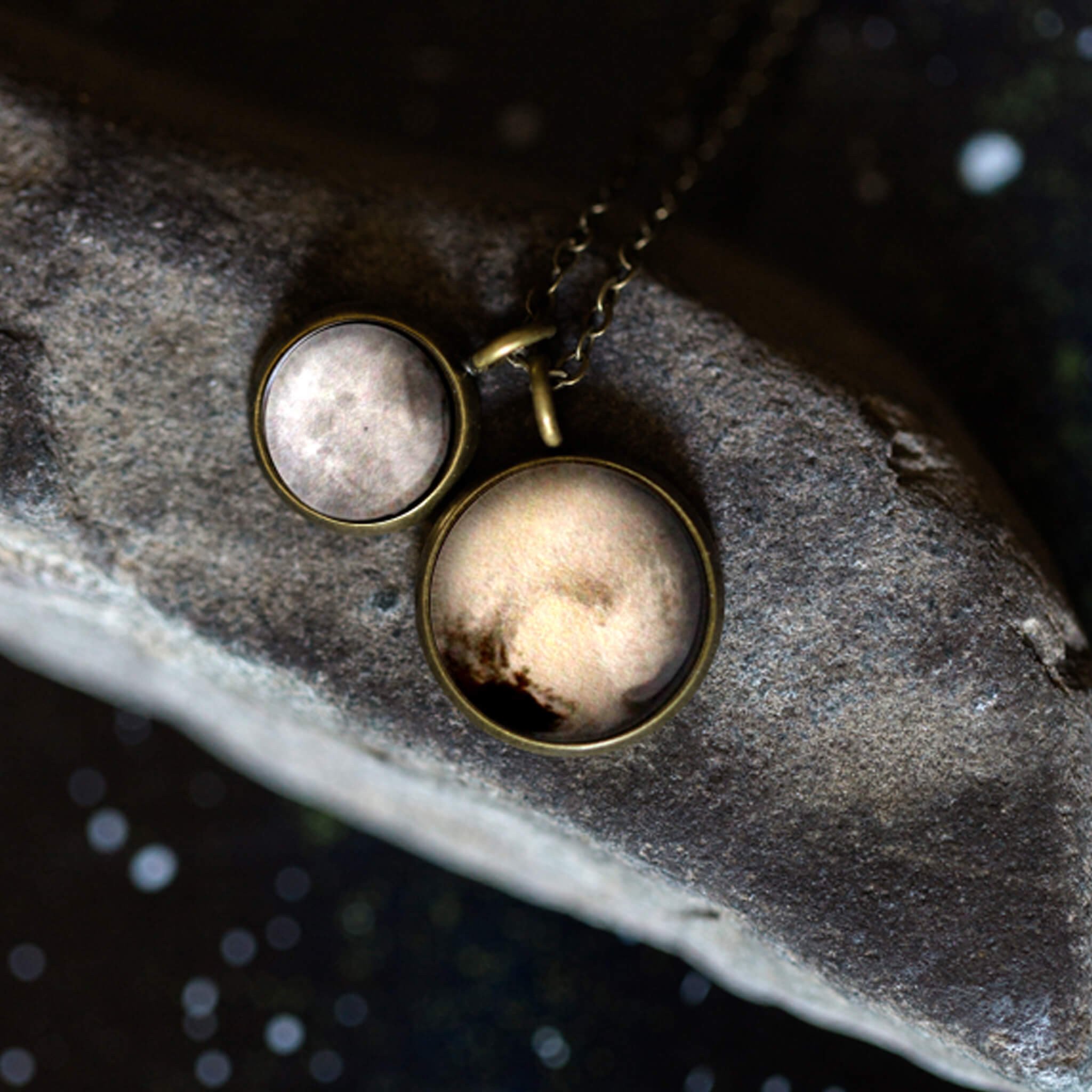 Layered necklace featuring Pluto and its moon Charon, inspired by New Horizons images, handcrafted with plated brass and glass.