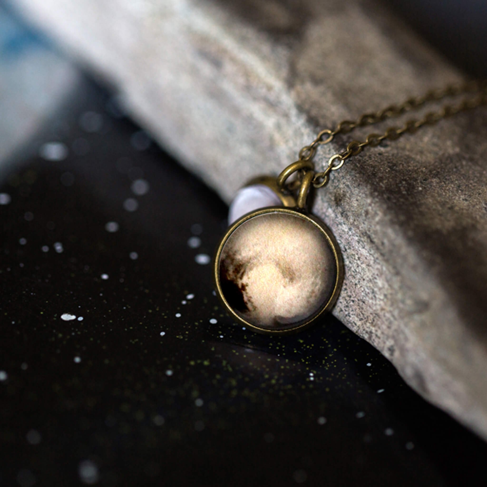 Layered necklace featuring Pluto and its moon Charon, inspired by New Horizons images, handcrafted with plated brass and glass.