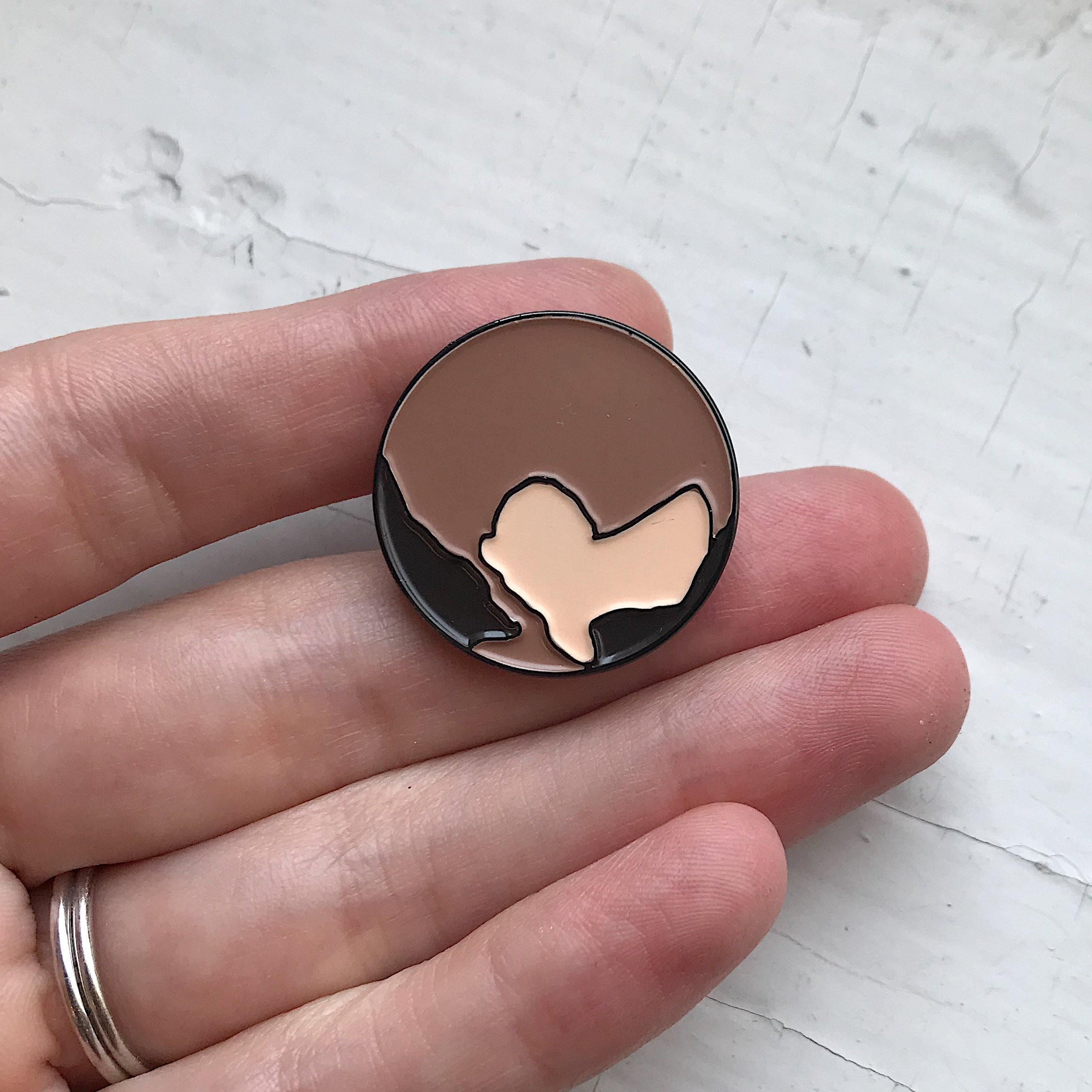 Pluto Enamel Pin featuring a whimsical illustration of Pluto, perfect for jackets and backpacks.