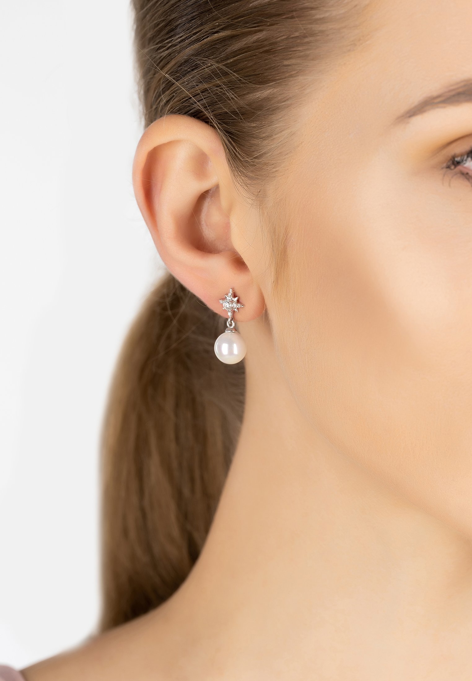 Polaris North Star Pearl Earrings featuring a starburst design with zirconia and a white pearl drop, crafted in sterling silver.