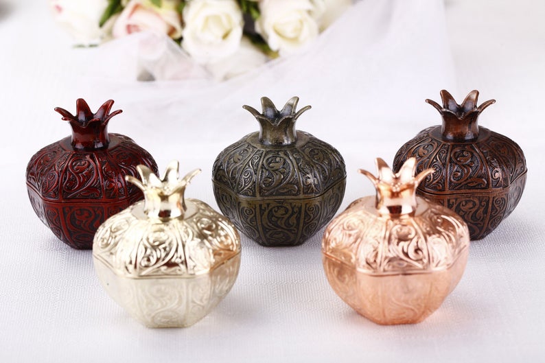 Set of 50 elegant pomegranate wedding favor boxes in various sizes, perfect for filling with treats.