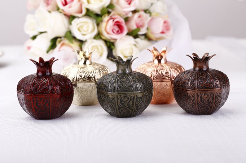 Set of 50 elegant pomegranate wedding favor boxes in various sizes, perfect for filling with treats.