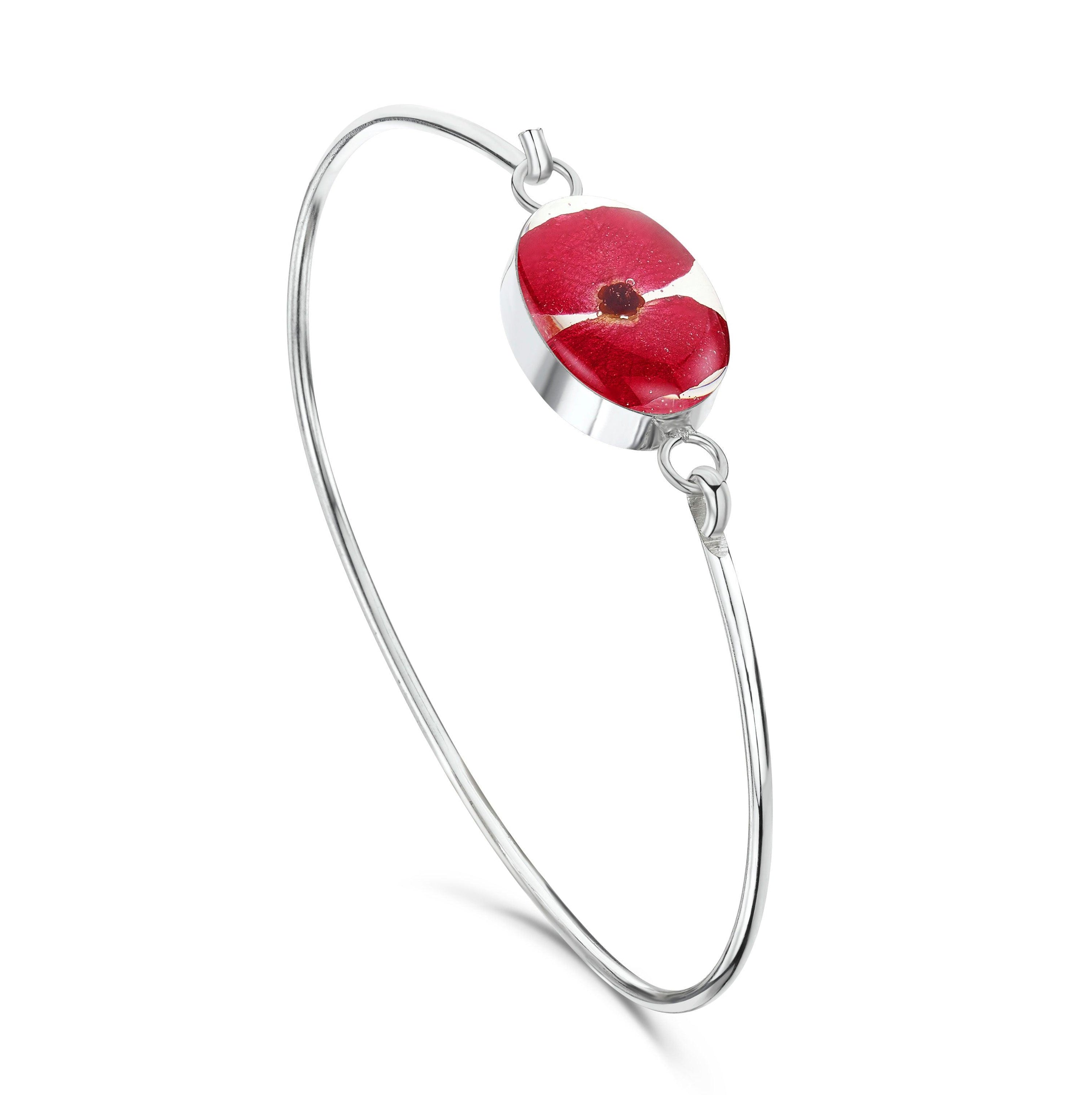 Sterling silver bangle featuring real poppy flowers, elegantly handcrafted by Shrieking Violet, displayed in a stylish gift box.