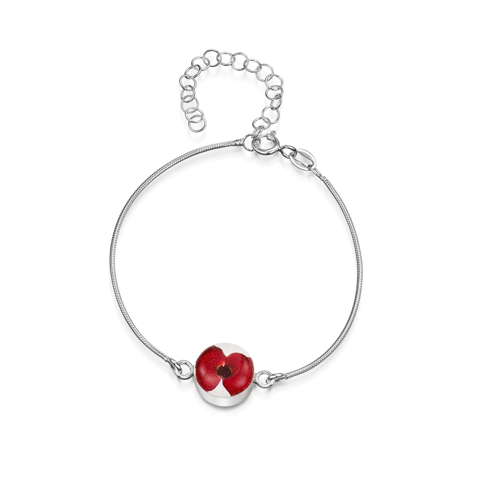 Poppy bracelet by Shrieking Violet® featuring a sterling silver snake chain and a handmade charm with real flowers set in resin.