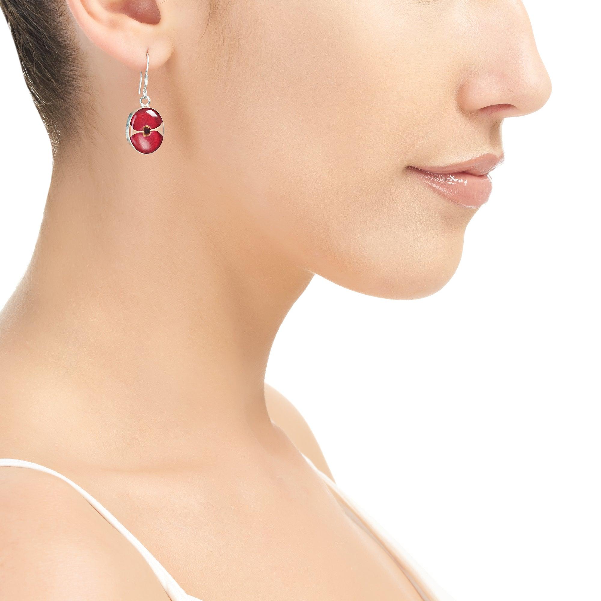 Sterling silver drop dangle earrings featuring real poppy flowers in an oval design, elegantly displayed in a gift box.