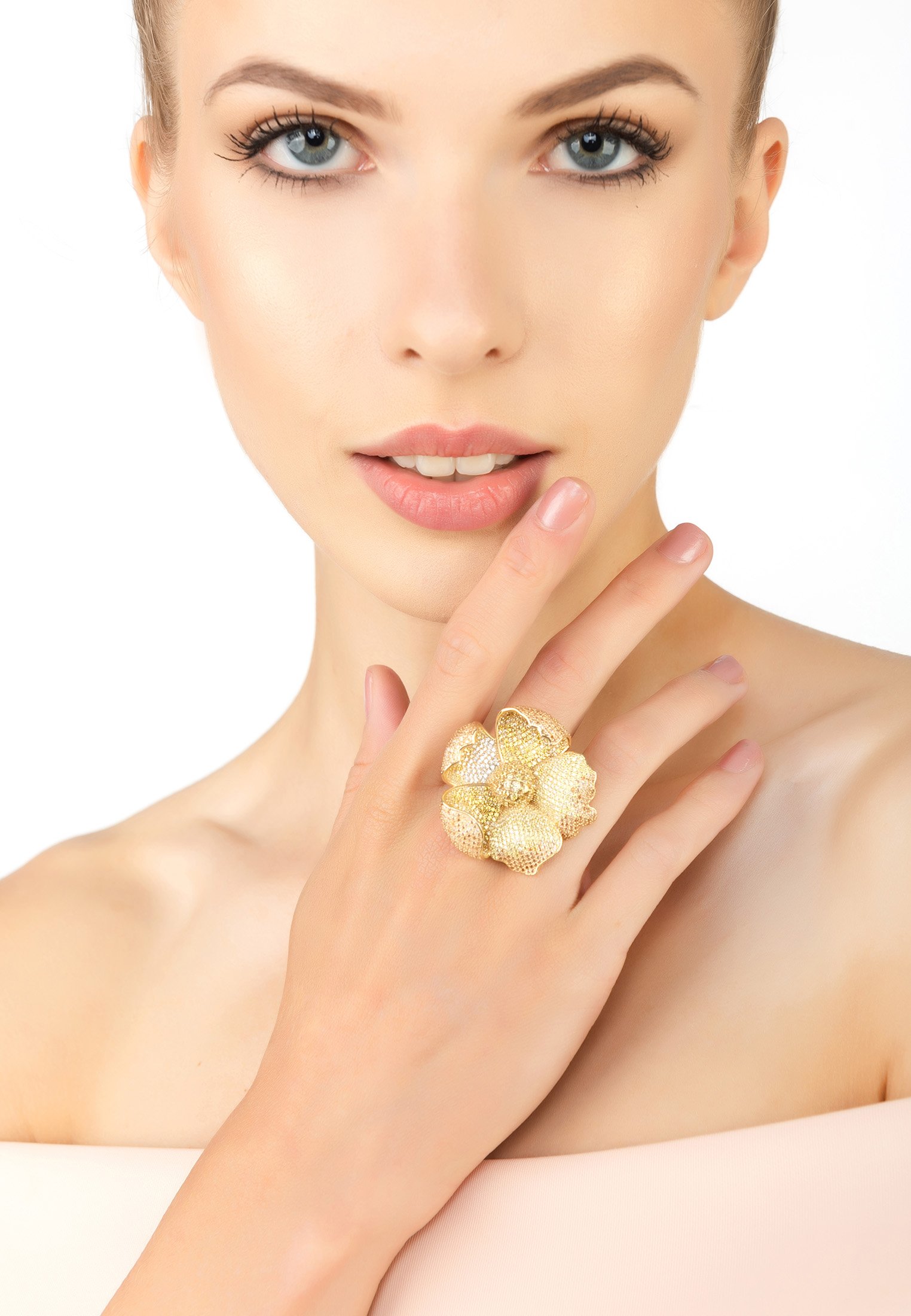 A stunning gold cocktail ring featuring a poppy flower design with sparkling cubic zirconia in shades of yellow and white.