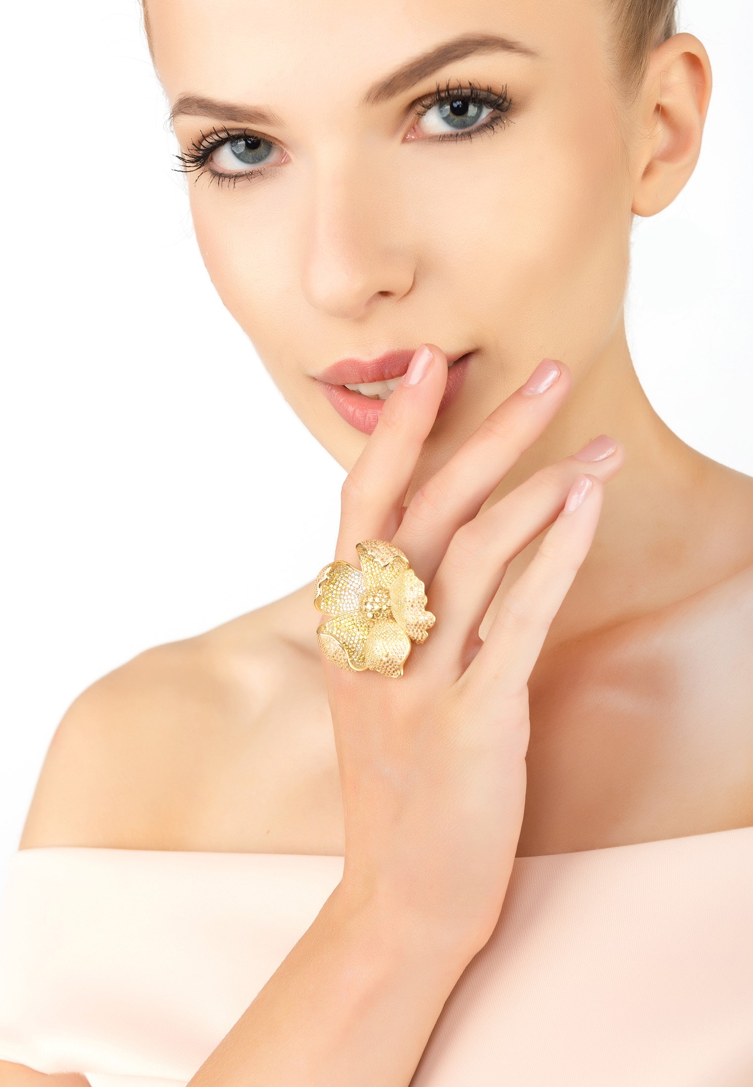 A stunning gold cocktail ring featuring a poppy flower design with sparkling cubic zirconia in shades of yellow and white.