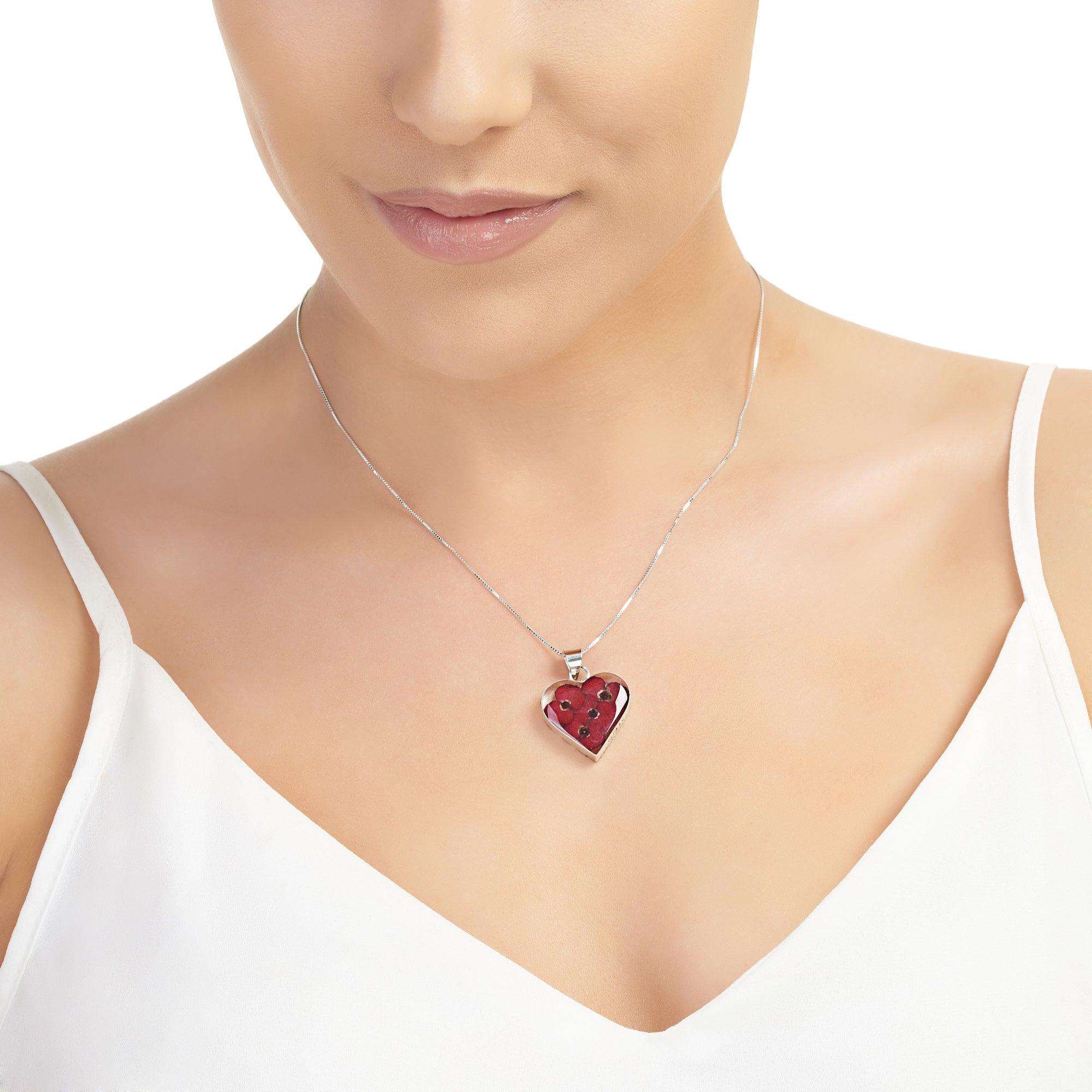 Poppy heart necklace by Shrieking Violet, featuring a sterling silver pendant with real poppy flowers, displayed in a stylish gift box.