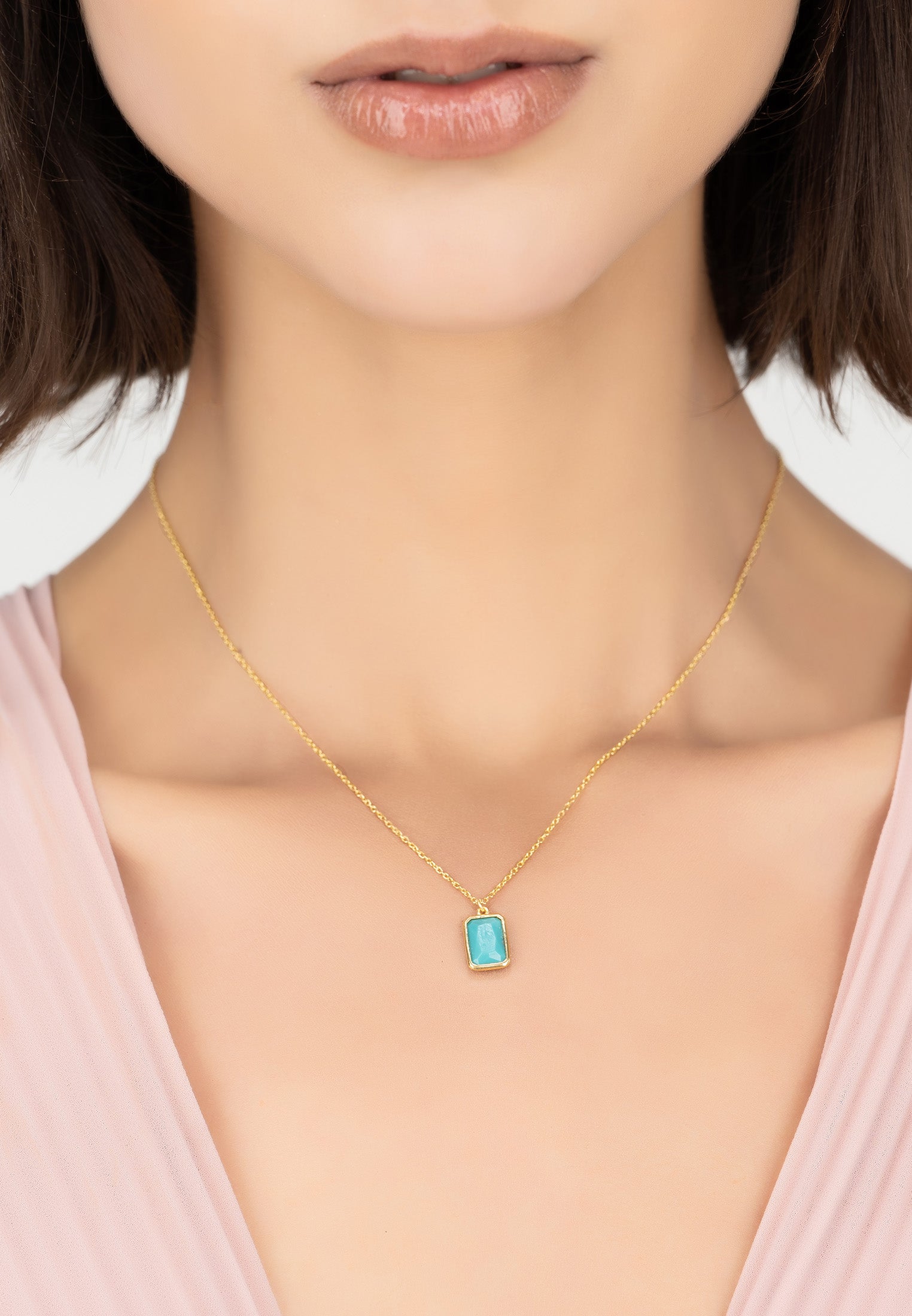 Portofino Necklace featuring a turquoise gemstone set in a gold-dipped sterling silver setting, elegantly displayed against a soft background.