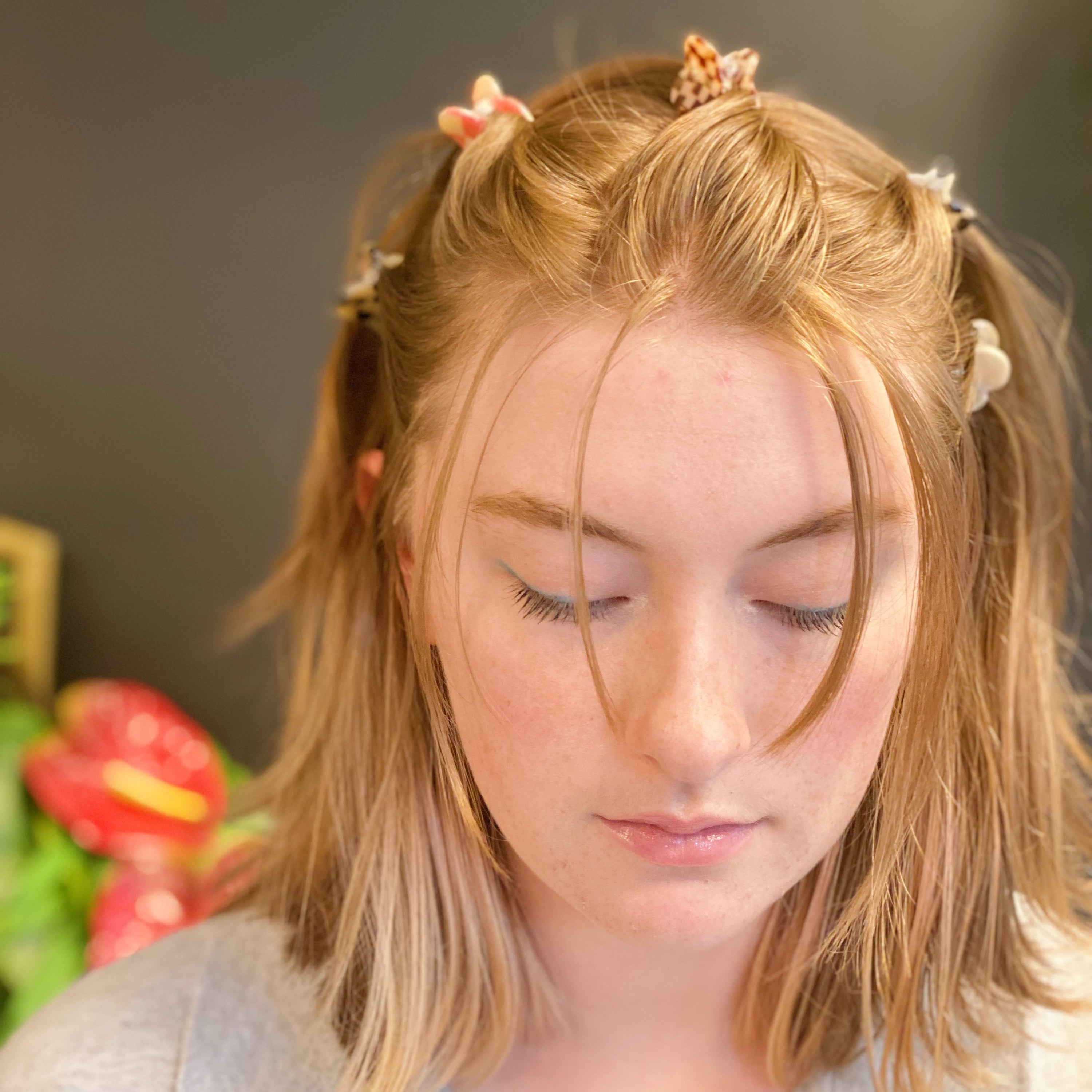 A set of five mini heart-shaped hair claws in various colors, elegantly packaged in a clear cello bag with the Ellison + Young logo.