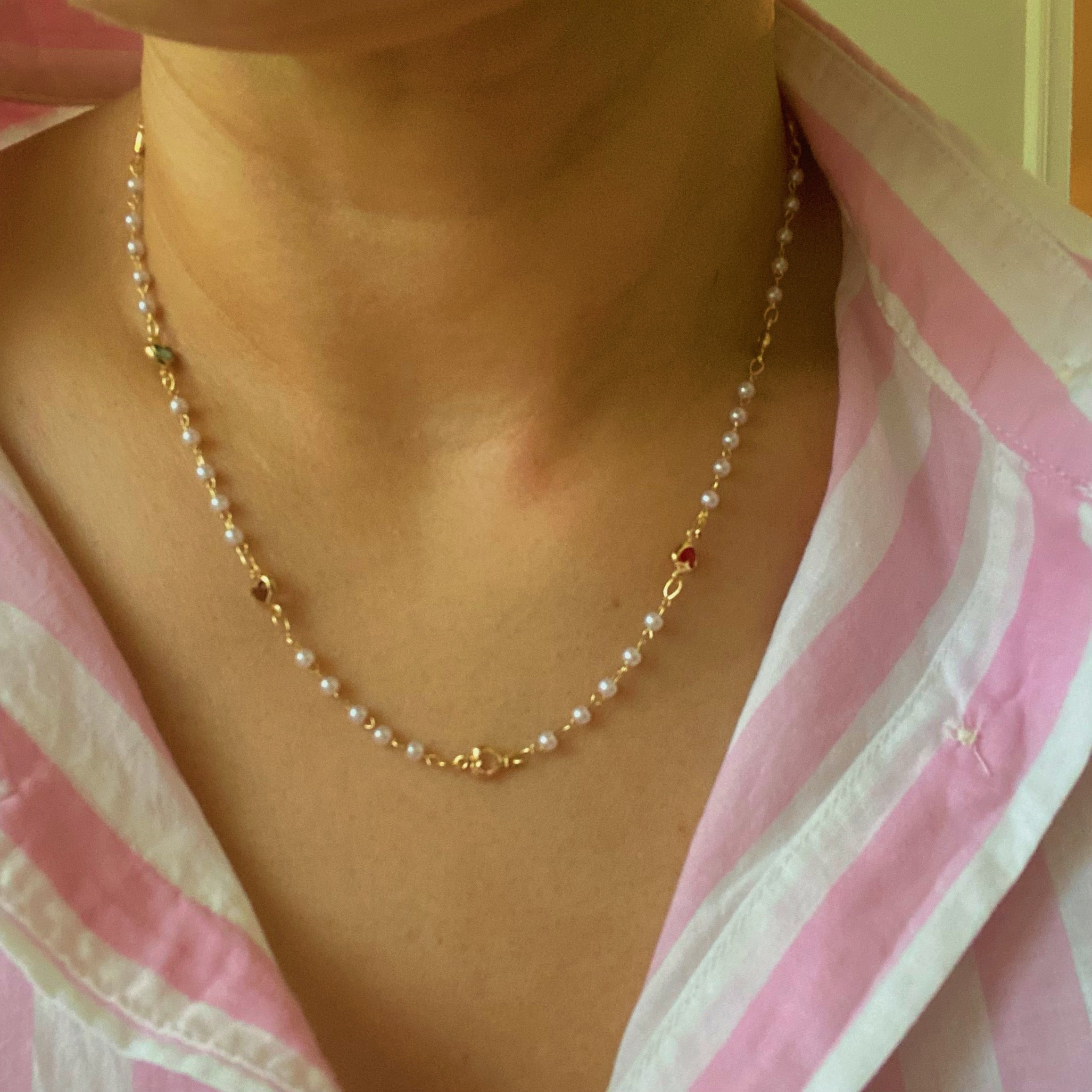 A delicate Precious Mini Heart Pearl Chain Necklace featuring tiny heart charms on a pearl chain, perfect for layering or solo wear.