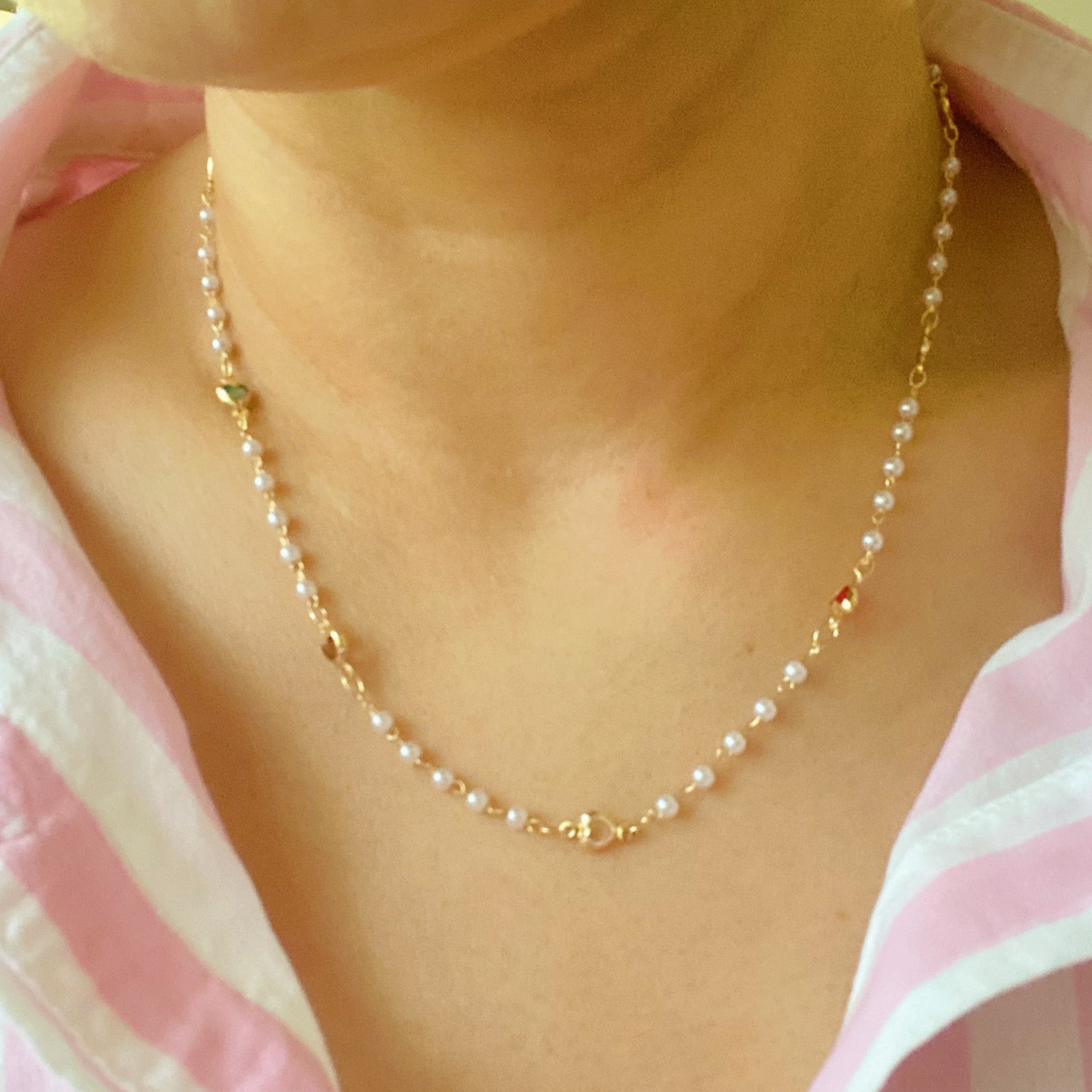 A delicate Precious Mini Heart Pearl Chain Necklace featuring tiny heart charms on a pearl chain, perfect for layering or solo wear.