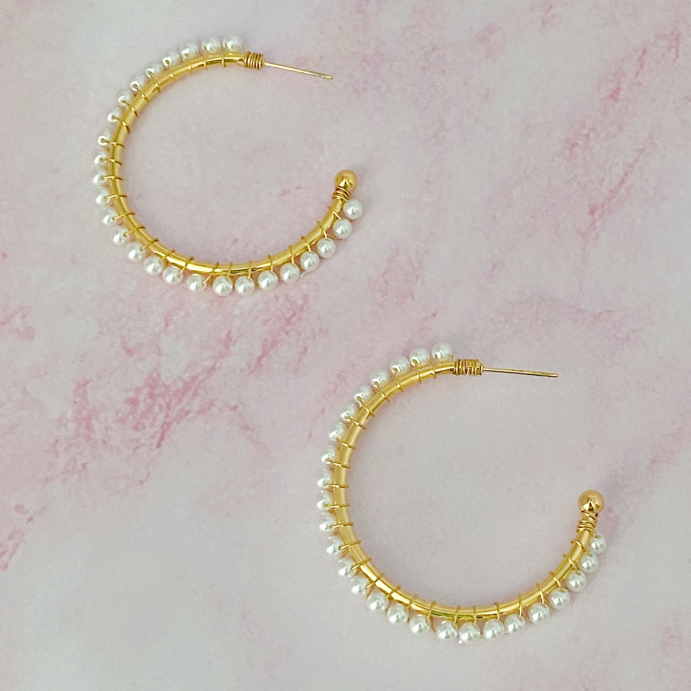 A pair of elegant Precious Pearl Bead Hoop Earrings featuring hand wired pearl beads and 18K gold plated brass, perfect for any occasion.