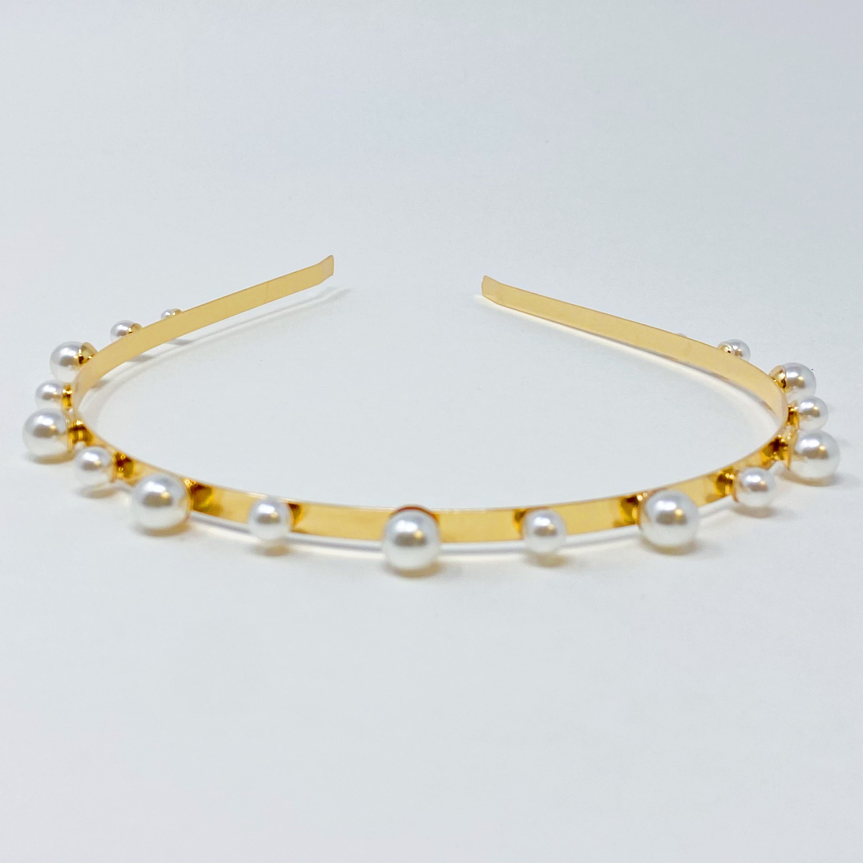 A set of two elegant pearl headbands, showcasing distinct designs and luxurious pearl detailing, perfect for any occasion.