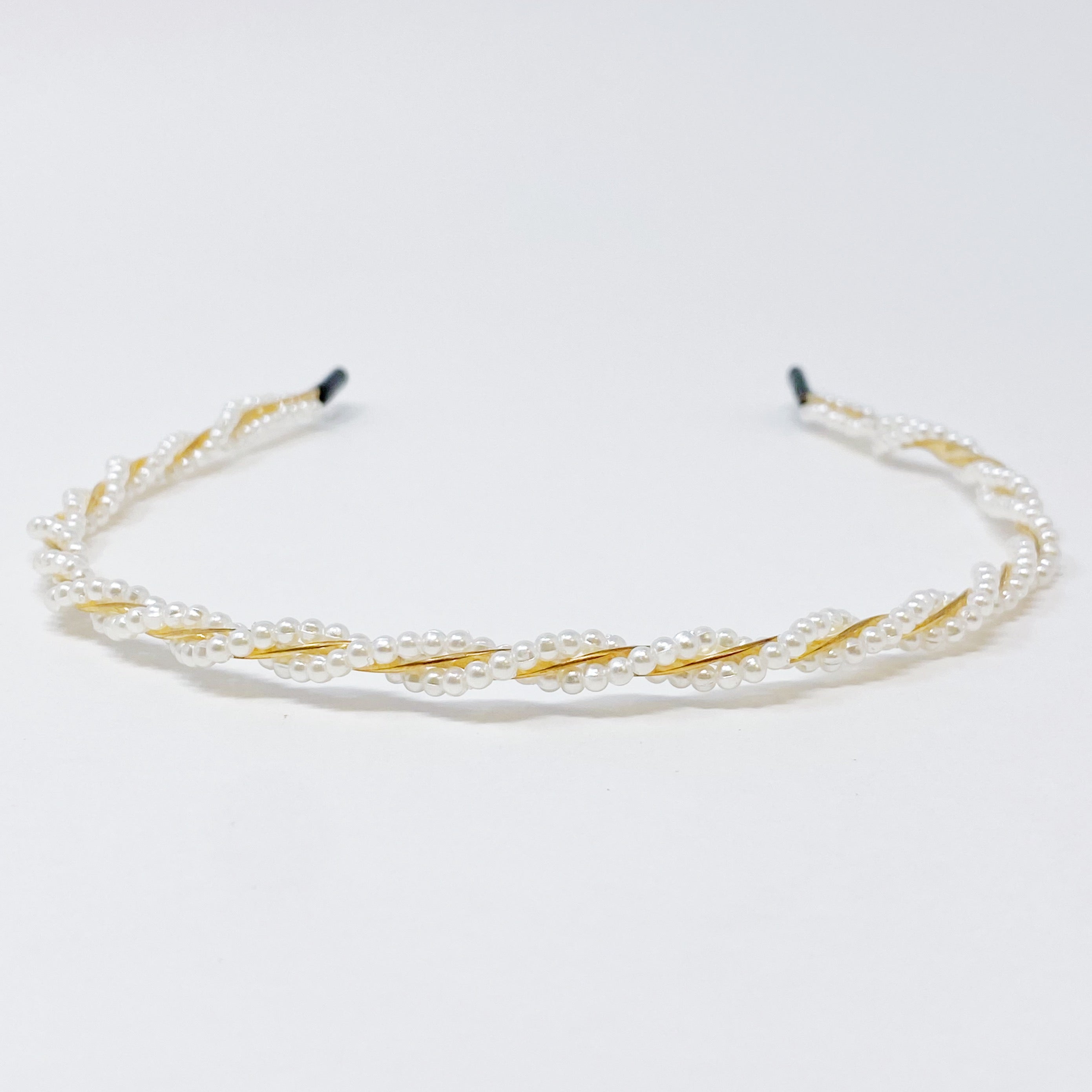 A set of two elegant pearl headbands, showcasing distinct designs and luxurious pearl detailing, perfect for any occasion.