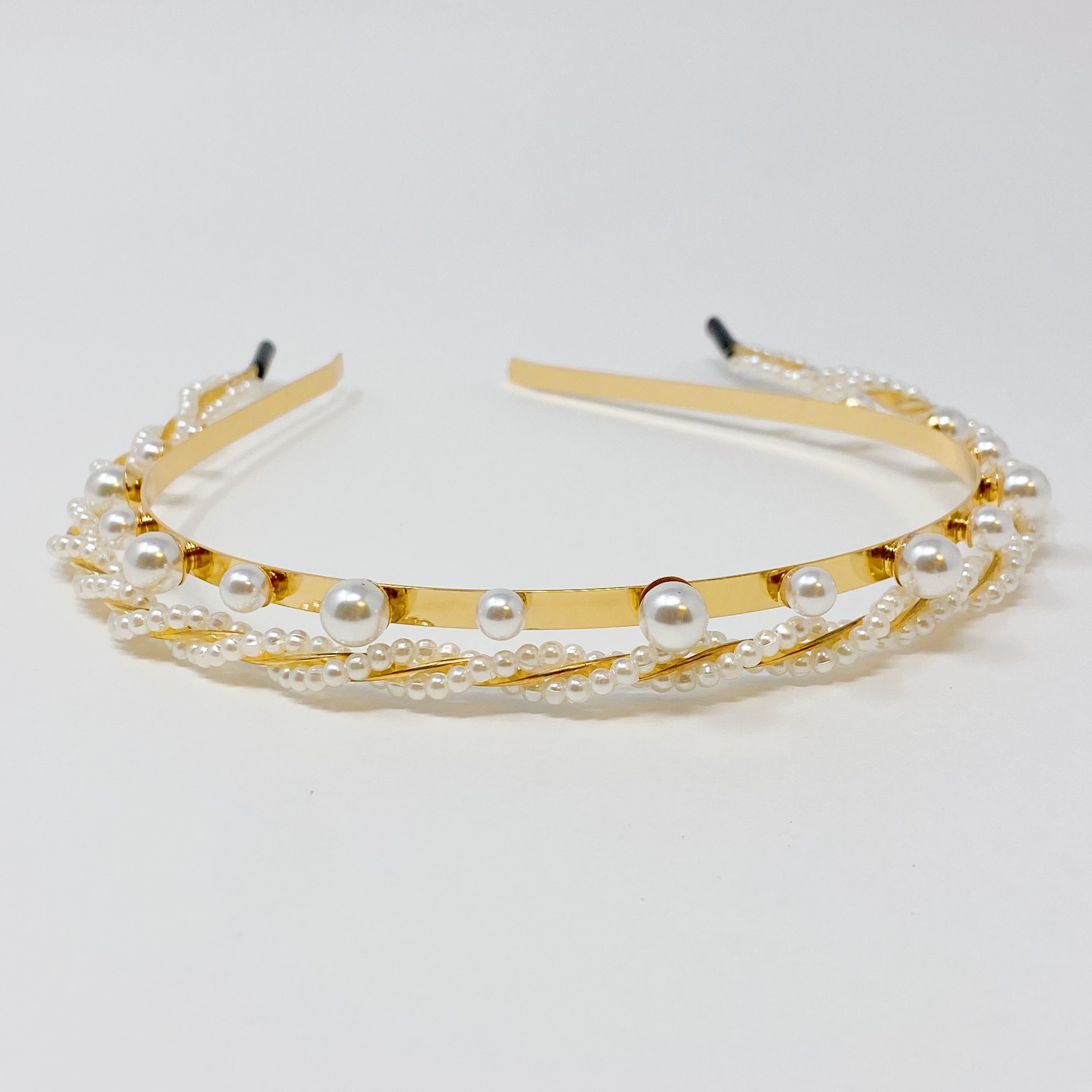 A set of two elegant pearl headbands, showcasing distinct designs and luxurious pearl detailing, perfect for any occasion.