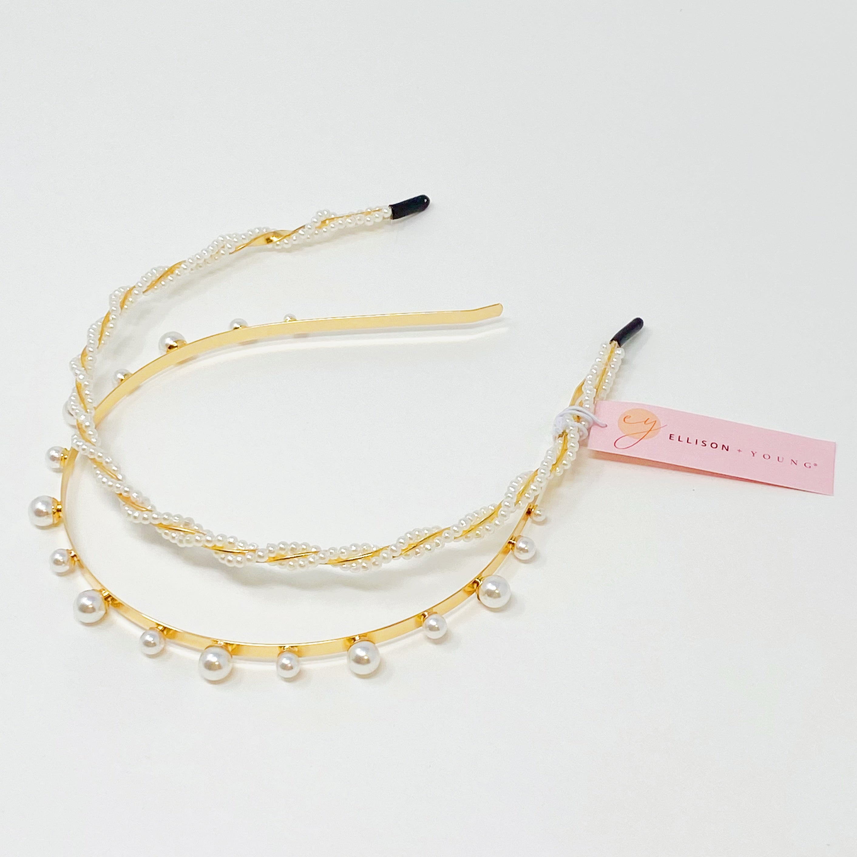 A set of two elegant pearl headbands, showcasing distinct designs and luxurious pearl detailing, perfect for any occasion.