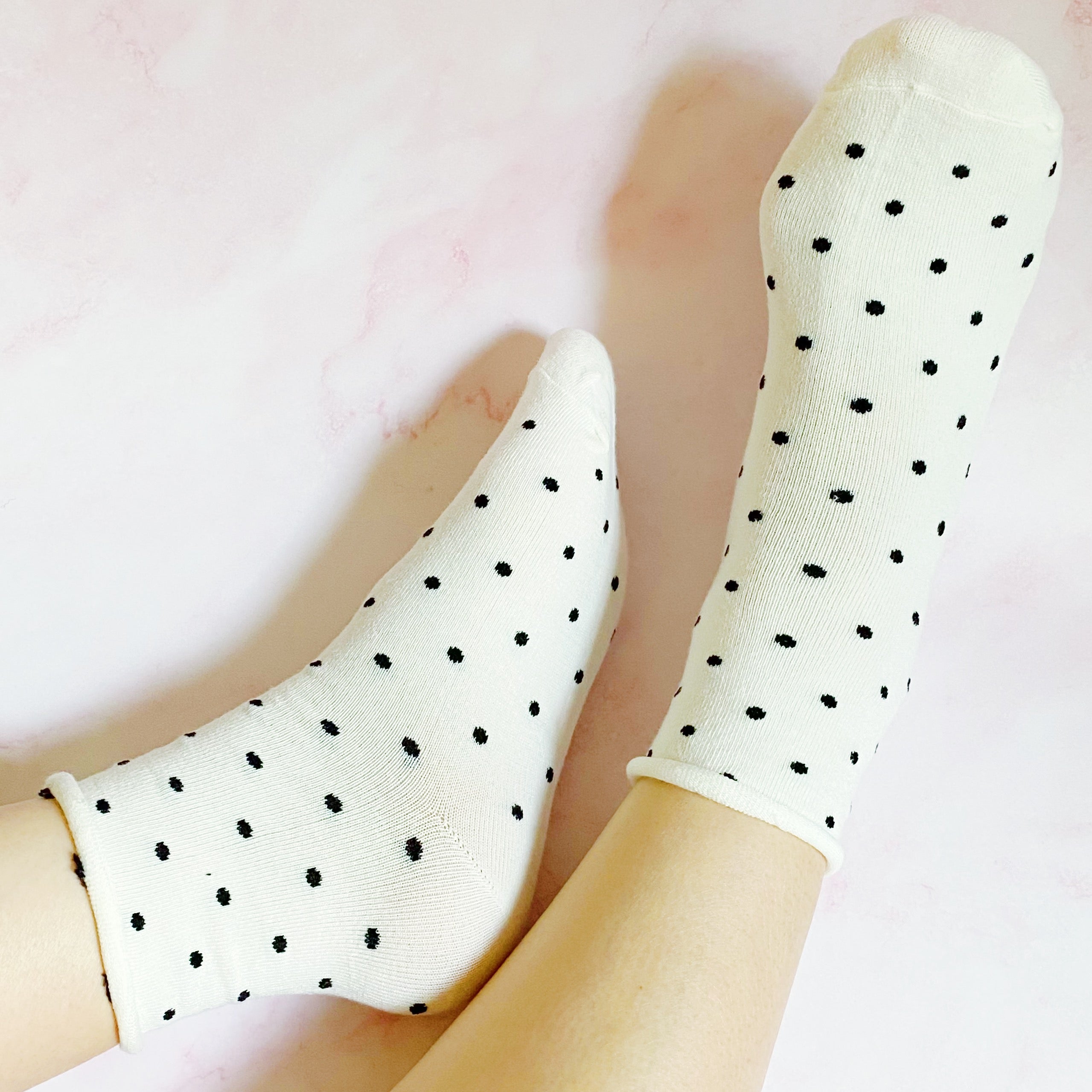 A set of three pairs of Precious Polka Dot Socks featuring colorful polka dots on a soft fabric, neatly packaged in a clear cello bag.