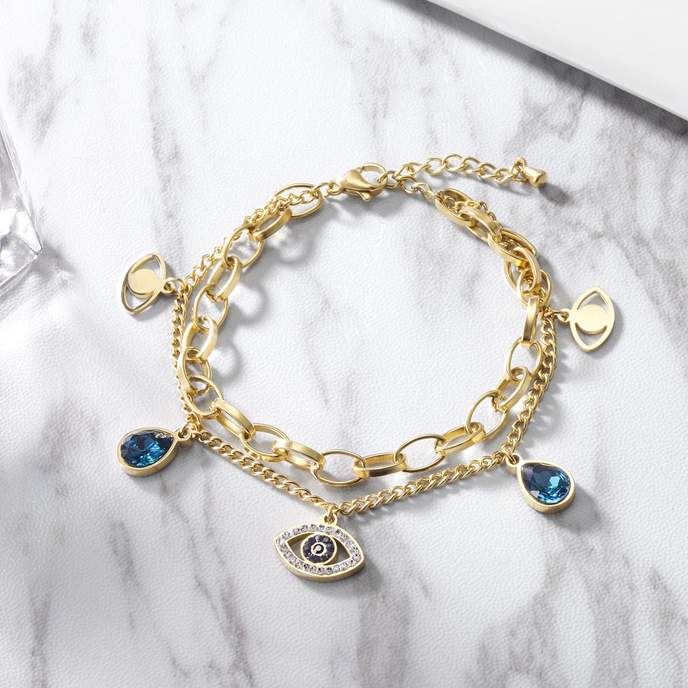 A stylish Prevent Harm Evil Eye Bracelet made of 316L surgical stainless steel with 14K gold PVD plating, featuring an evil eye design.