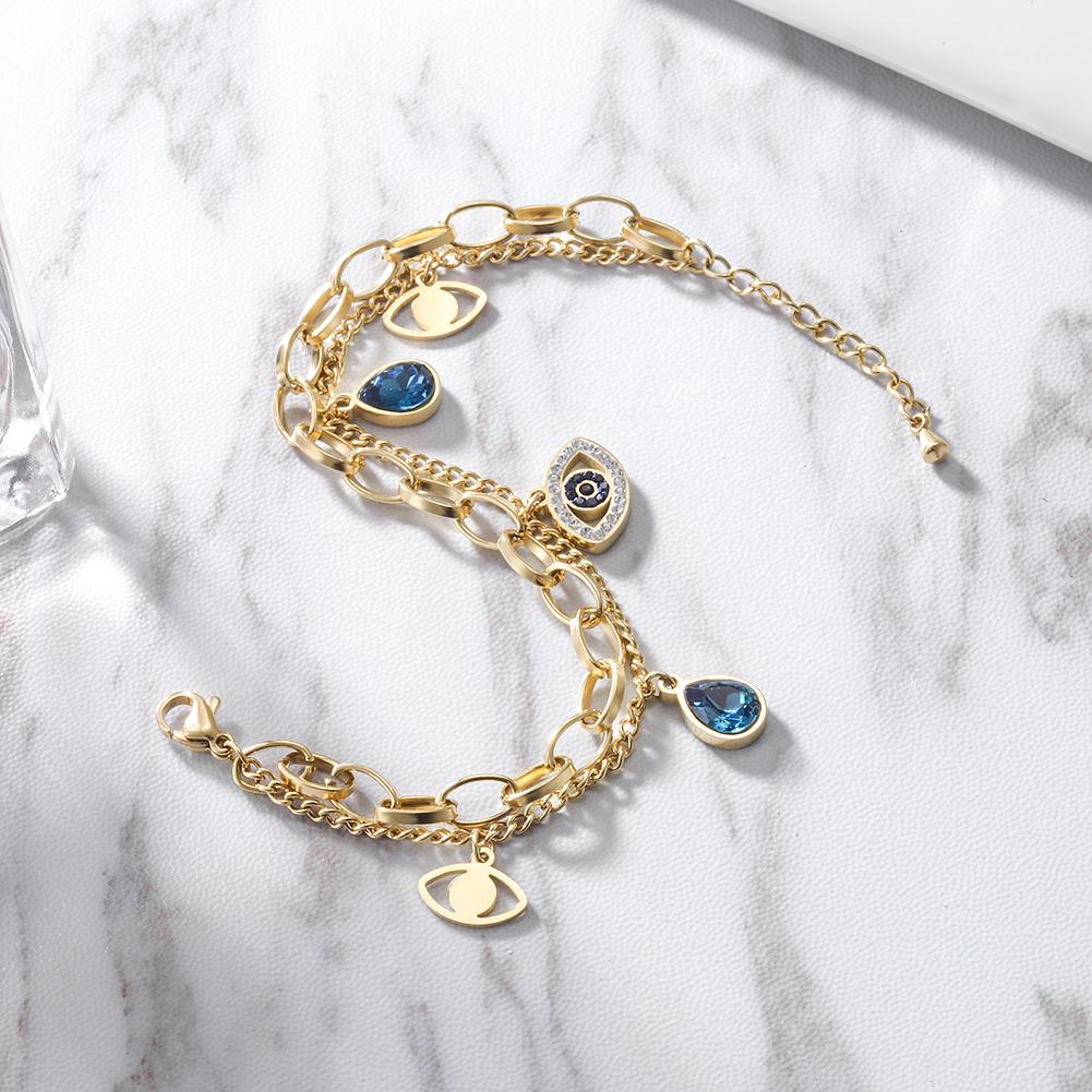 A stylish Prevent Harm Evil Eye Bracelet made of 316L surgical stainless steel with 14K gold PVD plating, featuring an evil eye design.