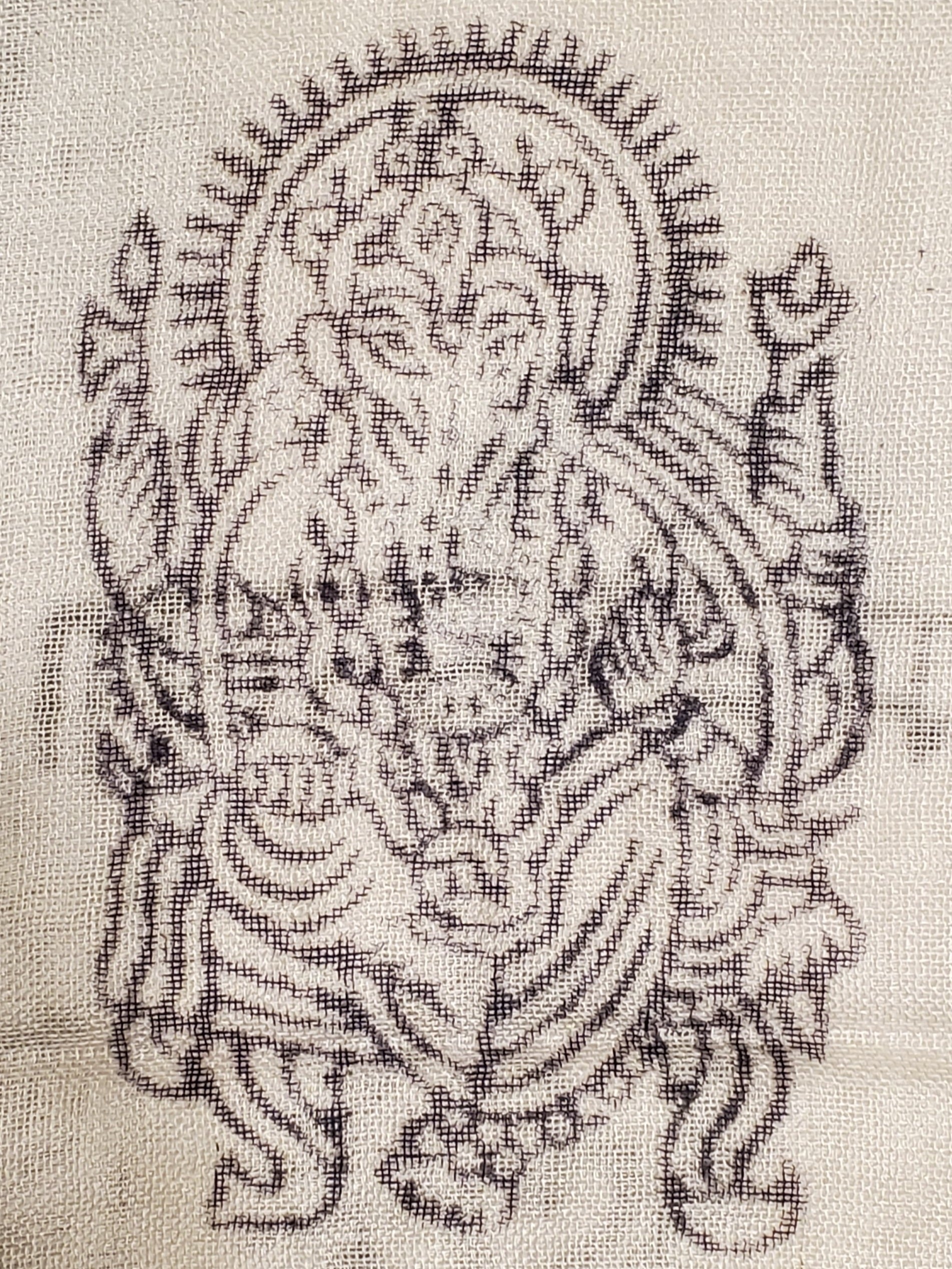 A vibrant scarf featuring the Om symbol and Ganesha, adorned with spiritual motifs like tridents, hearts, and henna patterns.