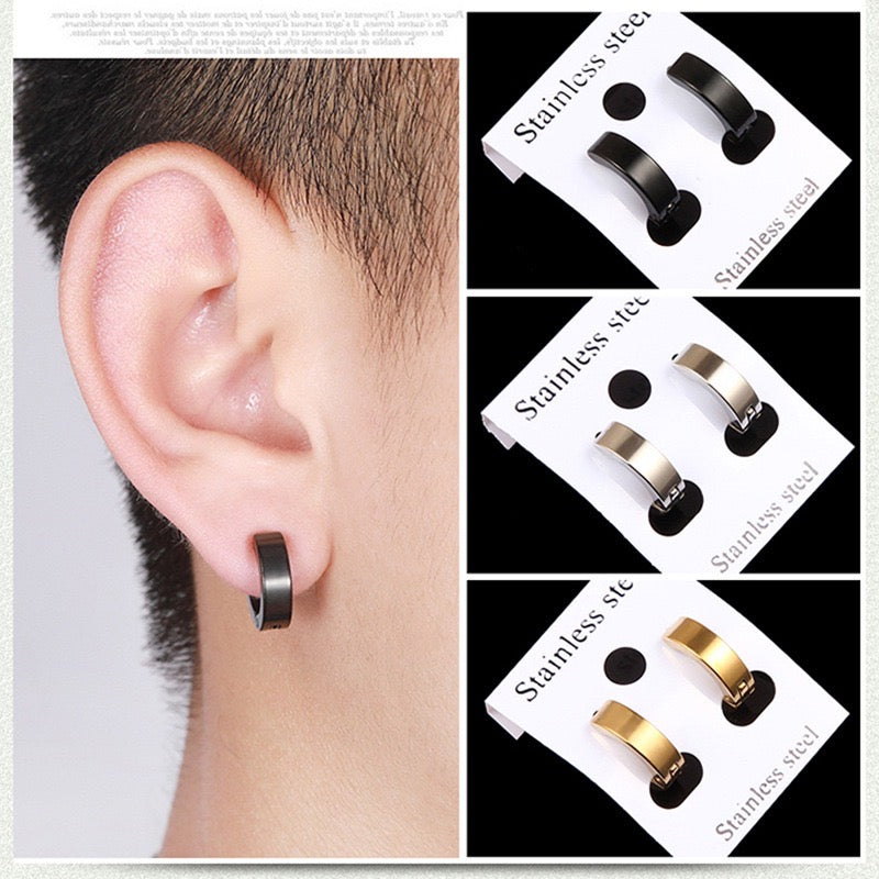 A collection of punk-inspired stainless steel men's ear studs featuring cross and hoop designs.