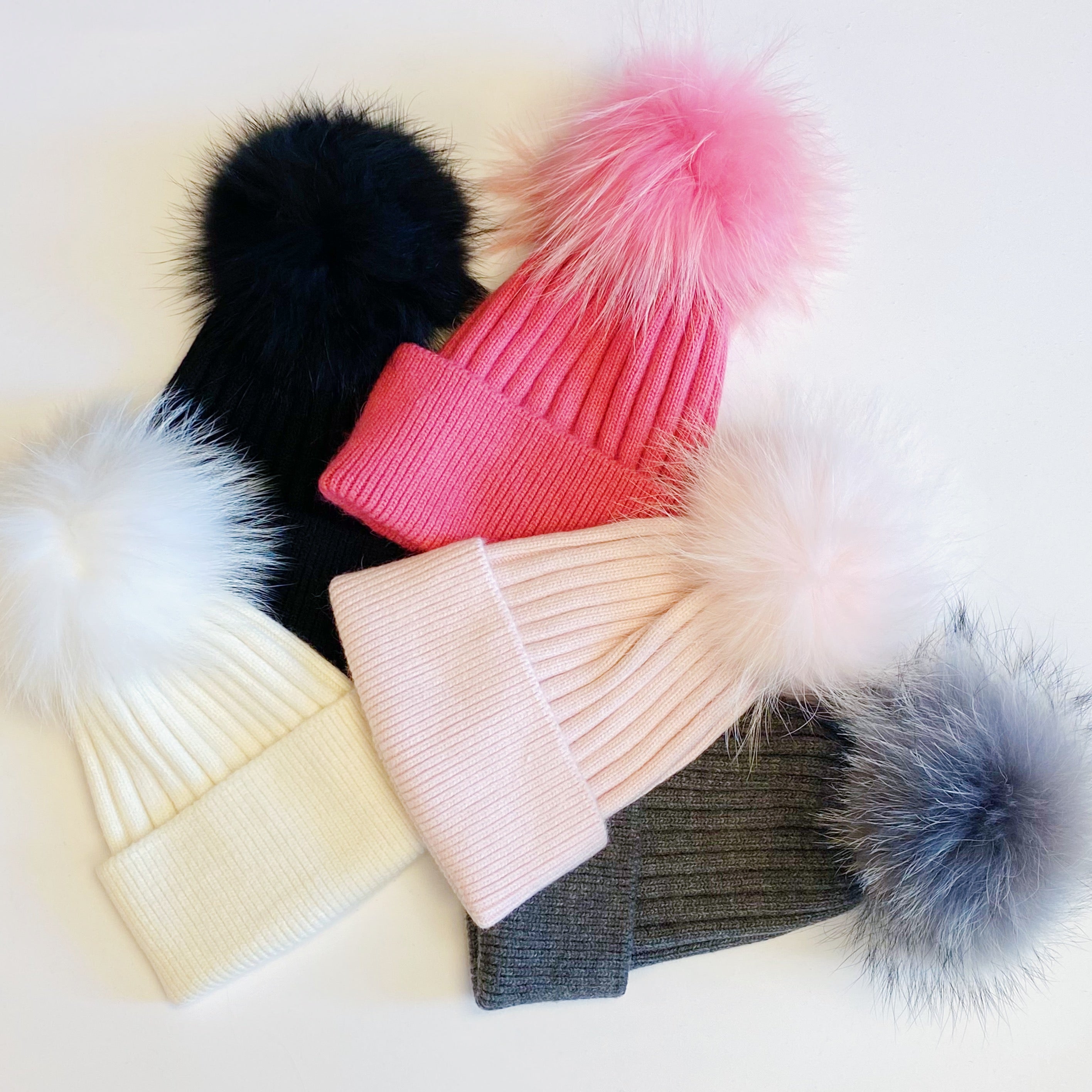 Luxurious Pure Angora Genuine Fur Luxe Beanie with raccoon fur pom pom, showcasing a soft knit design in a stylish fold-over style.